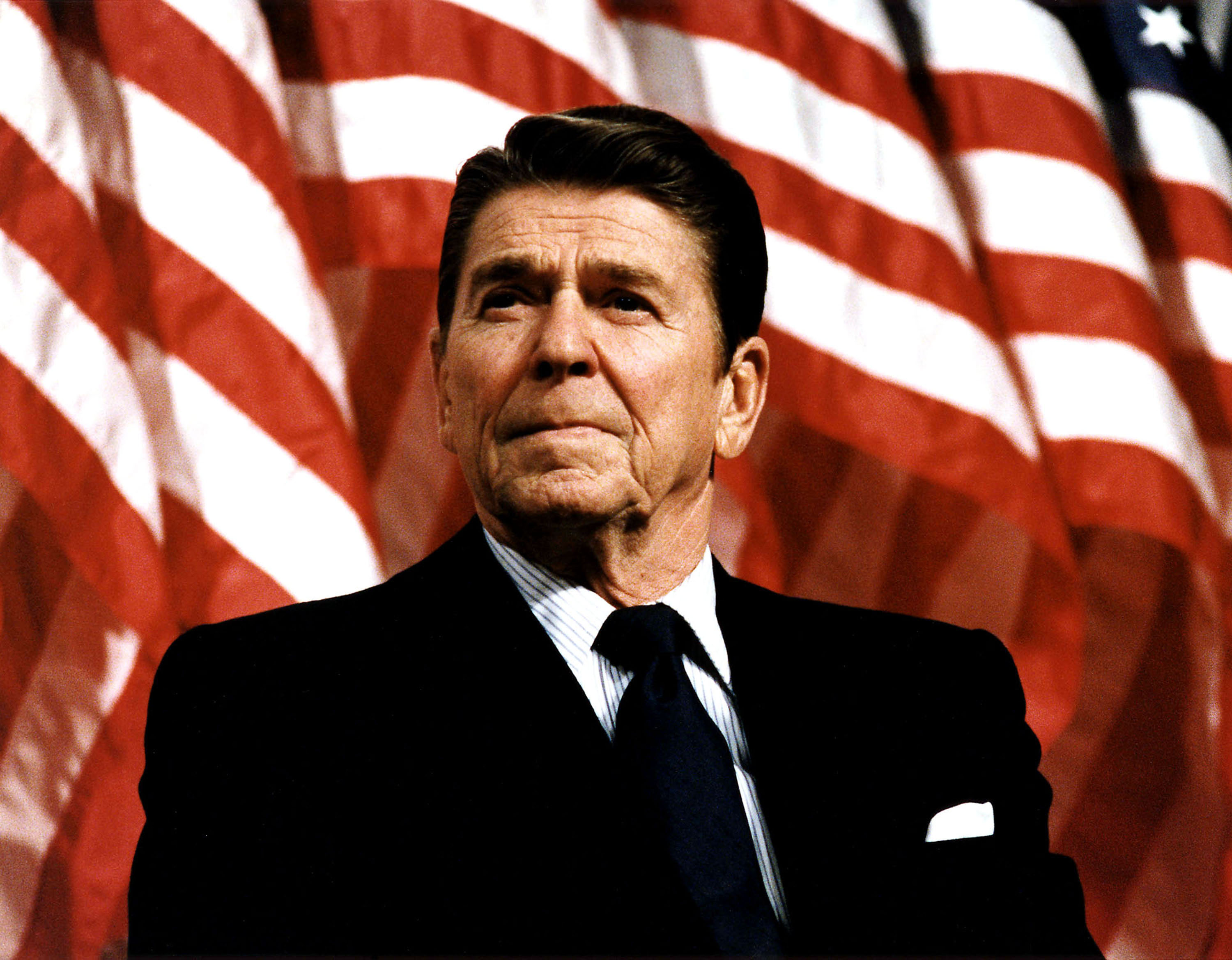 Ronald Reagan in front of flags