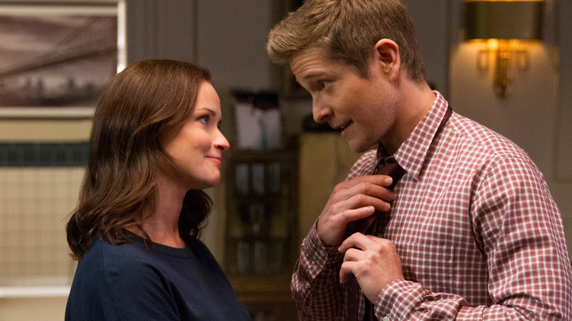 Alexis Bledel stands in front of Matt Czuchry as he adjusts his tie on 'Gilmore Girls: A Year in the Life' in 2016