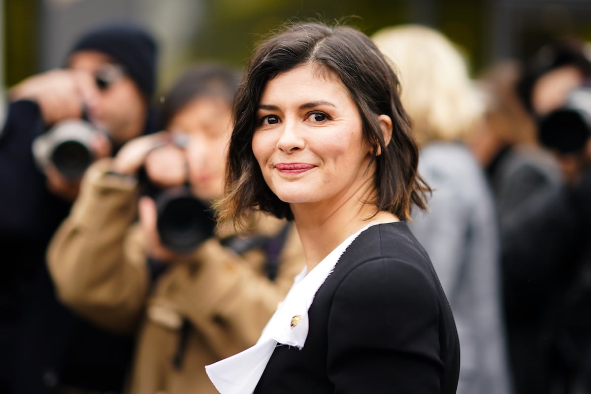 Audrey Tautou wears a black jacket with white lapels, outside Balmain, during Paris Fashion Week