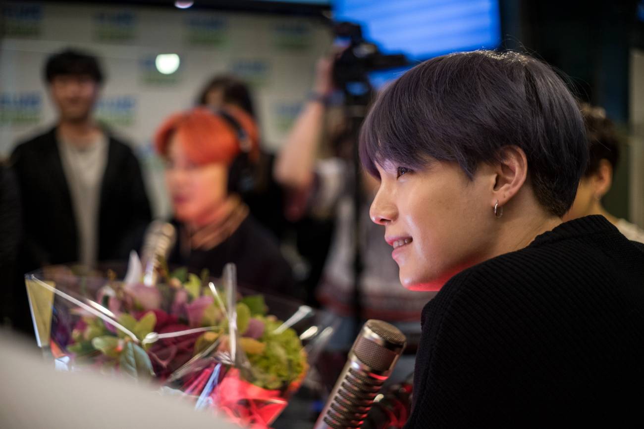 BTS Suga in front of microphone at radio station