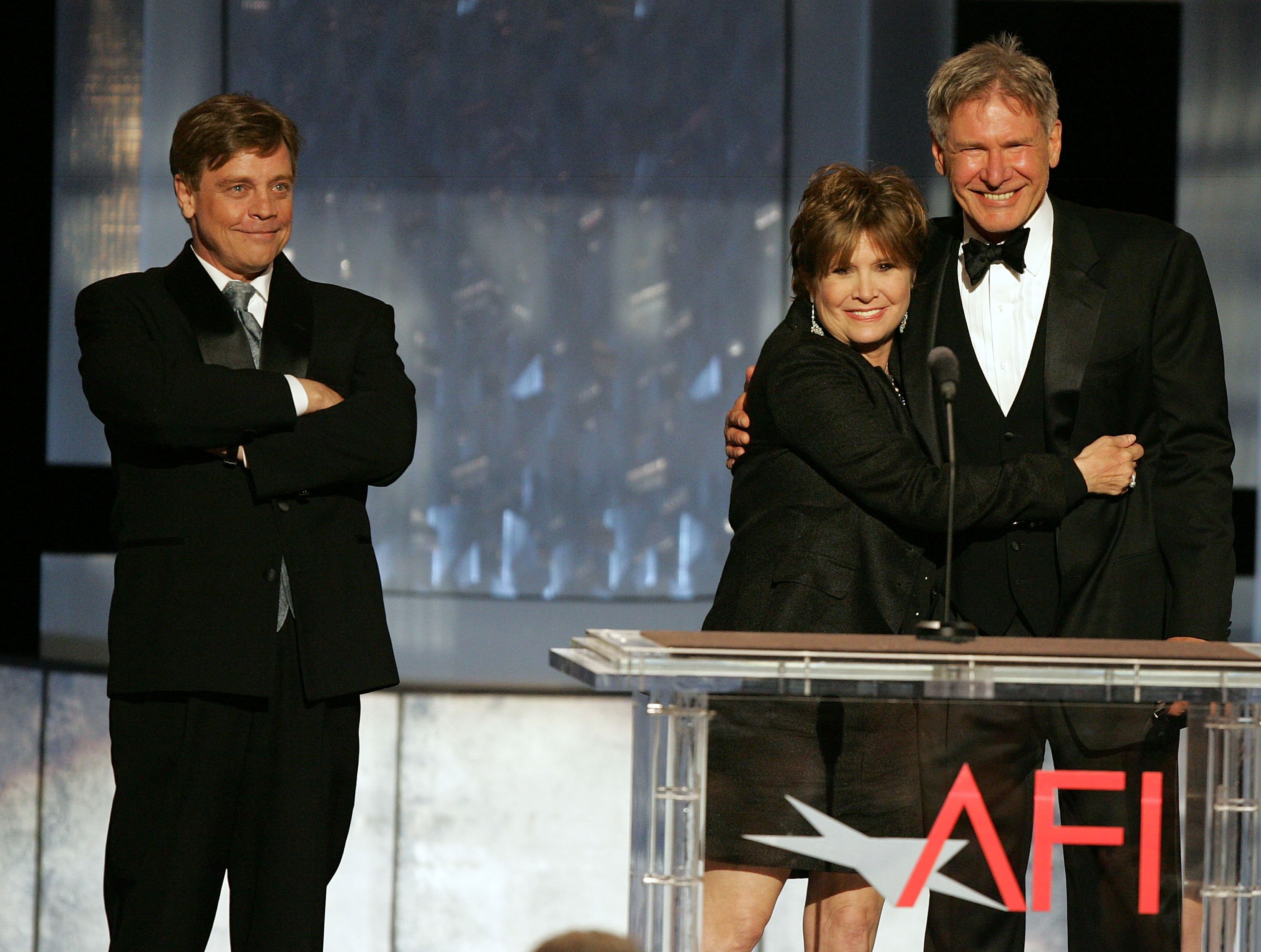 HOLLYWOOD - JUNE 09: (L-R) Actors Mark Hamill, Carrie Fisher and Harrison Ford speak onstage during the 33rd AFI Life Achievement Award tribute to George Lucas at the Kodak Theatre on June 9, 2005 in Hollywood, California.