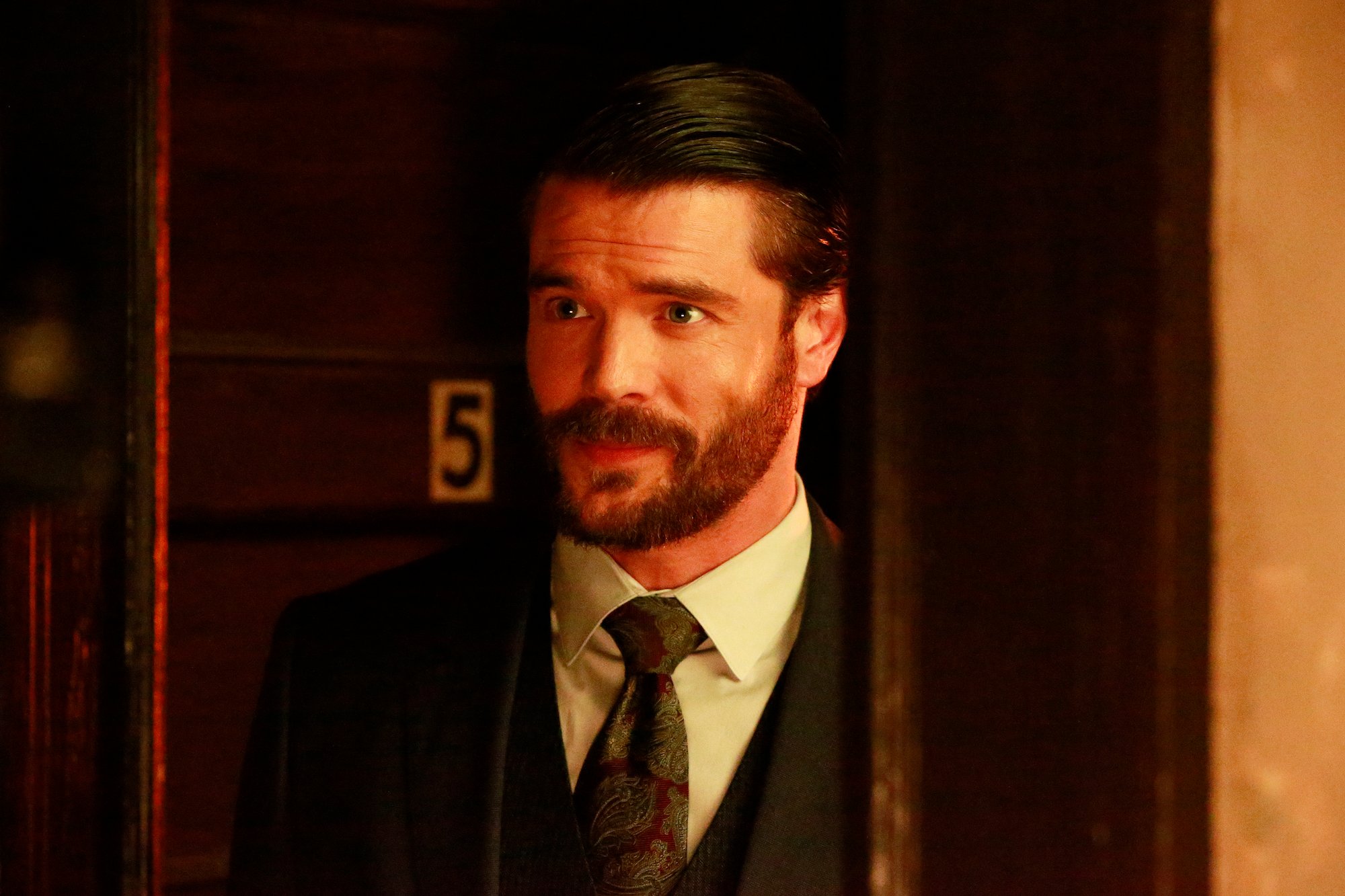 Charlie Weber as Frank Delfino looking off to the side
