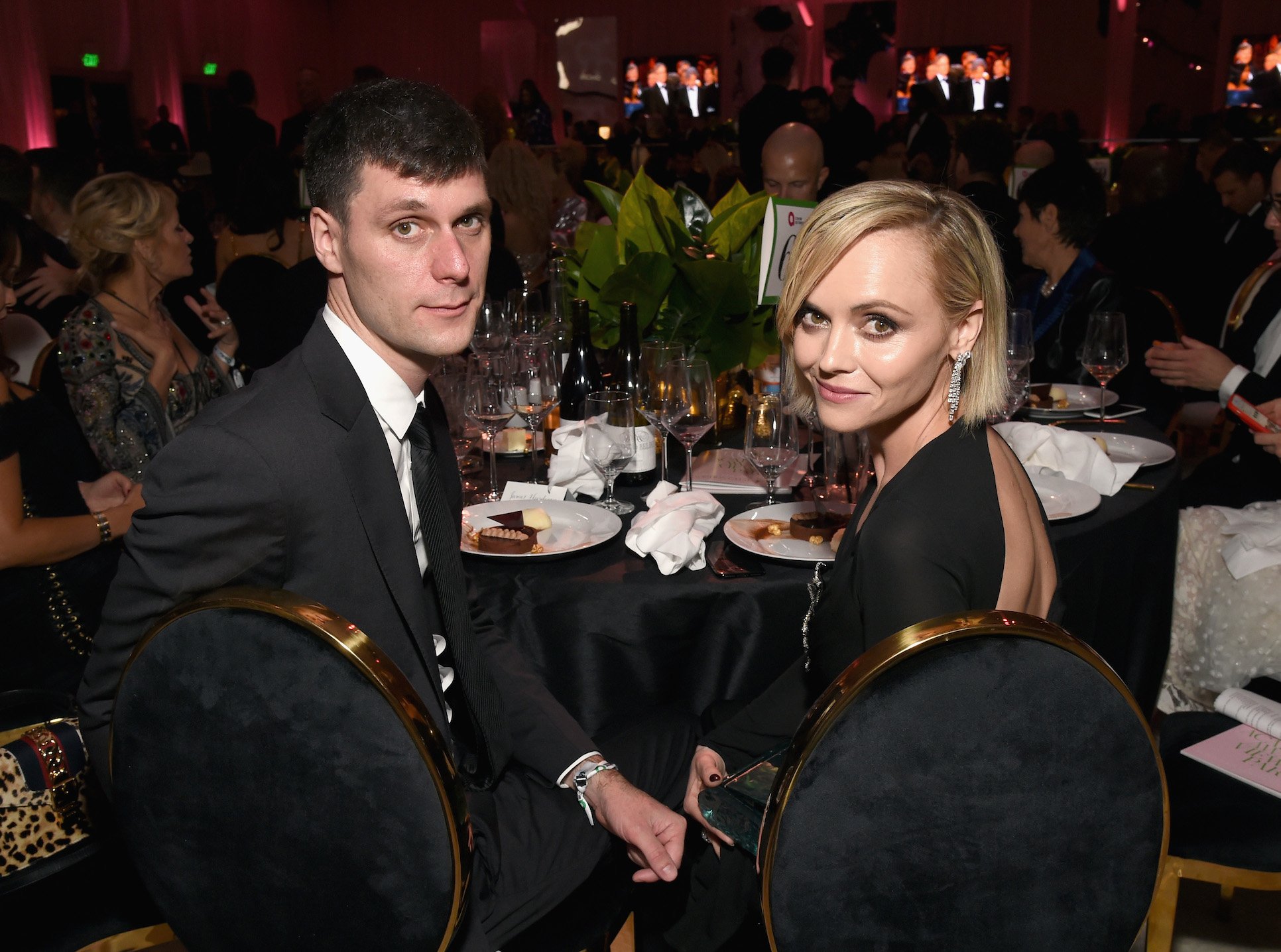 James Heerdegen (L) and Christina Ricci attend the 27th annual Elton John AIDS Foundation Academy Awards