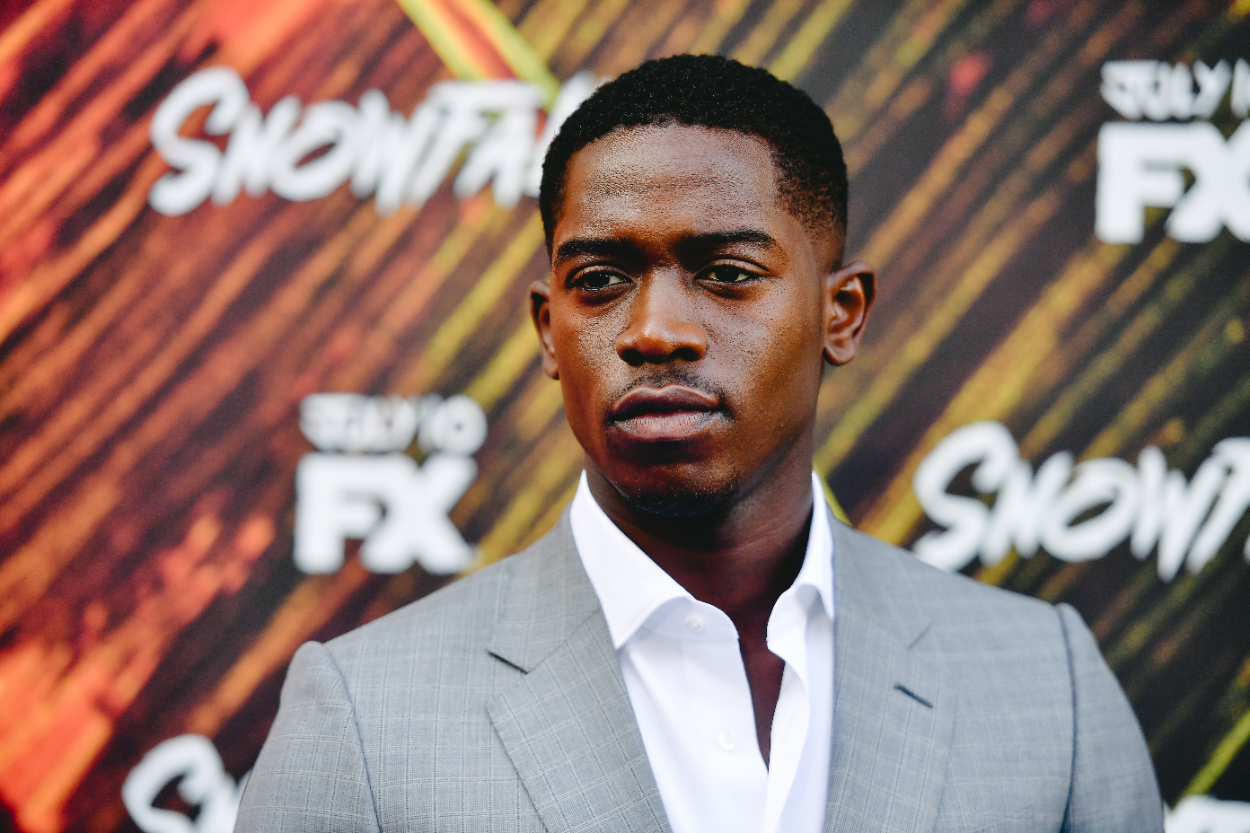 Damson Idris wears a suit to an event for his show 'Snowfall'
