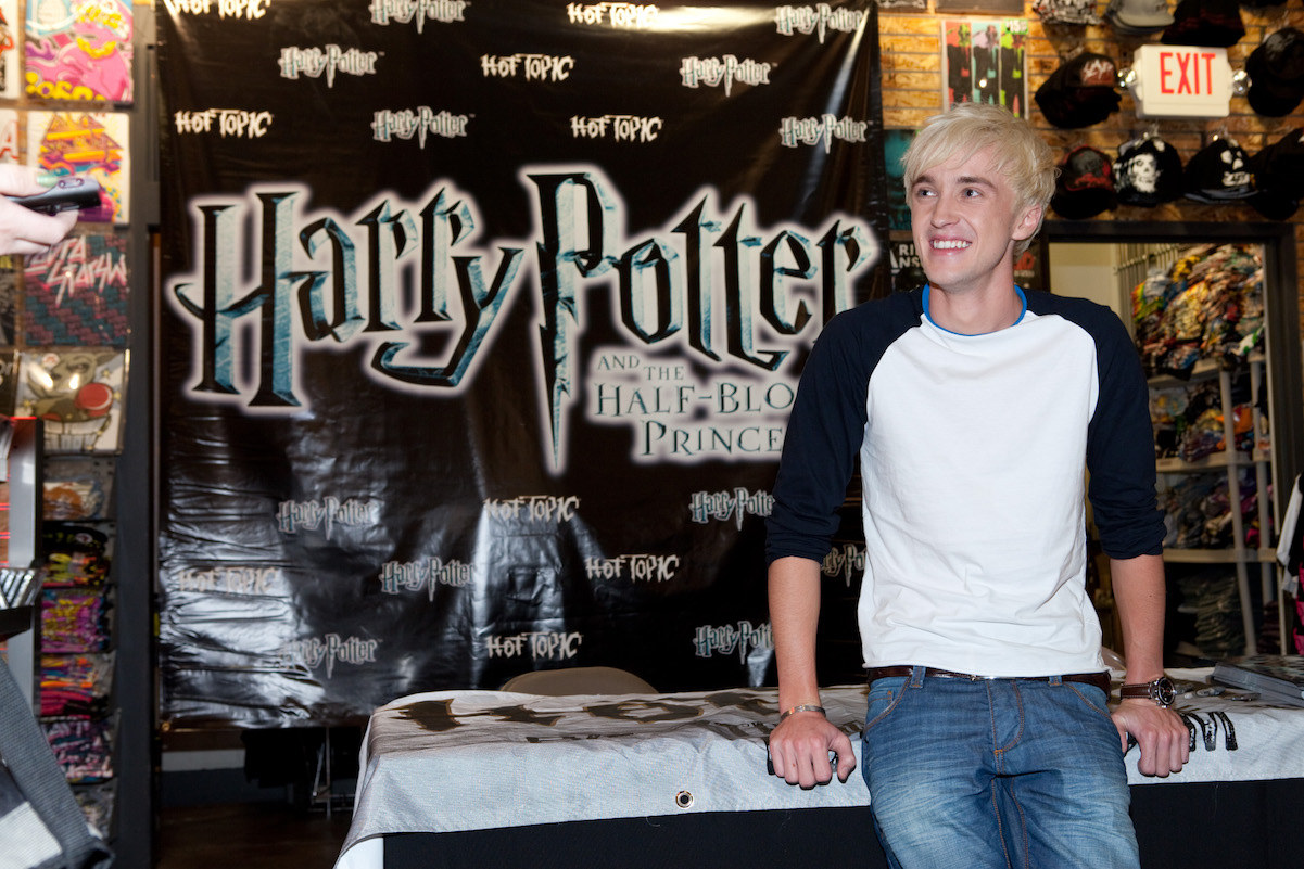 Tom Felton poses while at an event for his character Draco Malfoy from the 'Harry Potter' book series.