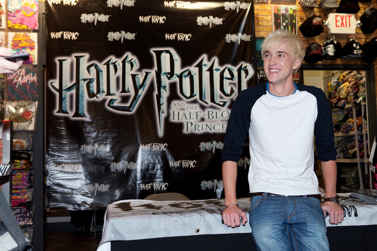 Tom Felton poses while at an event for his character Draco Malfoy from the 'Harry Potter' book series.