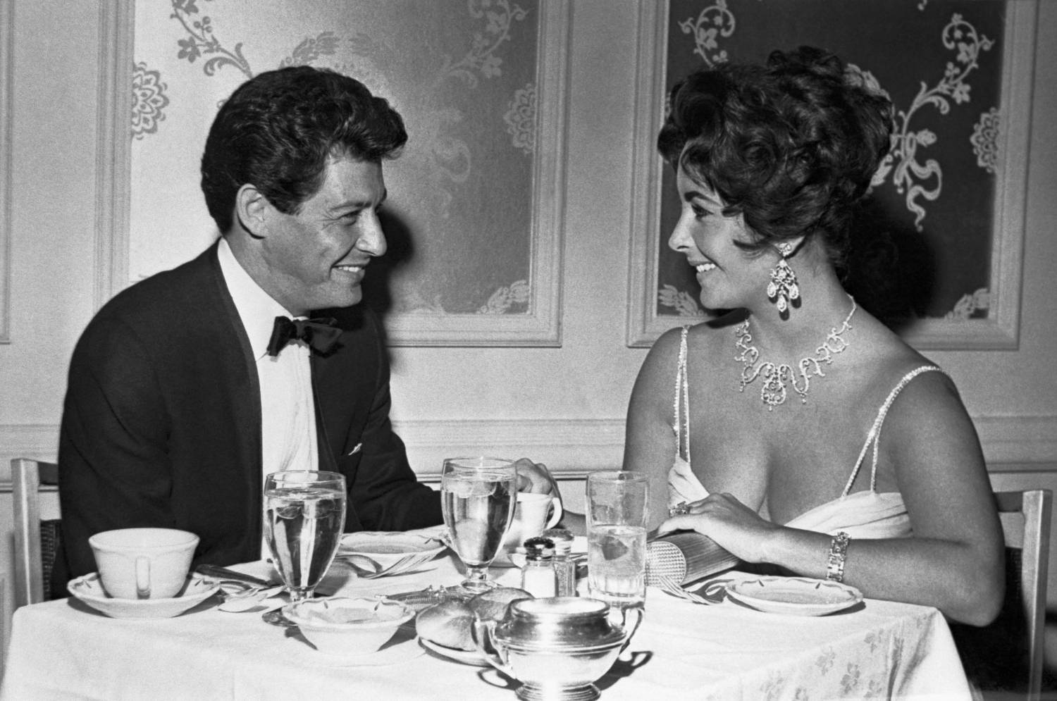 Crooner Eddie Fisher and betrothed actress Elizabeth Taylor huddle over last minute plans for their Las Vegas wedding Tuesday, to follow his expected divorce from Debbie Reynolds in Las Vegas Monday. Fisher and Miss Taylor plan to be united in a simple civil ceremony at the spacious ranch where she has been staying during his appearance at the Hotel Tropicana.
