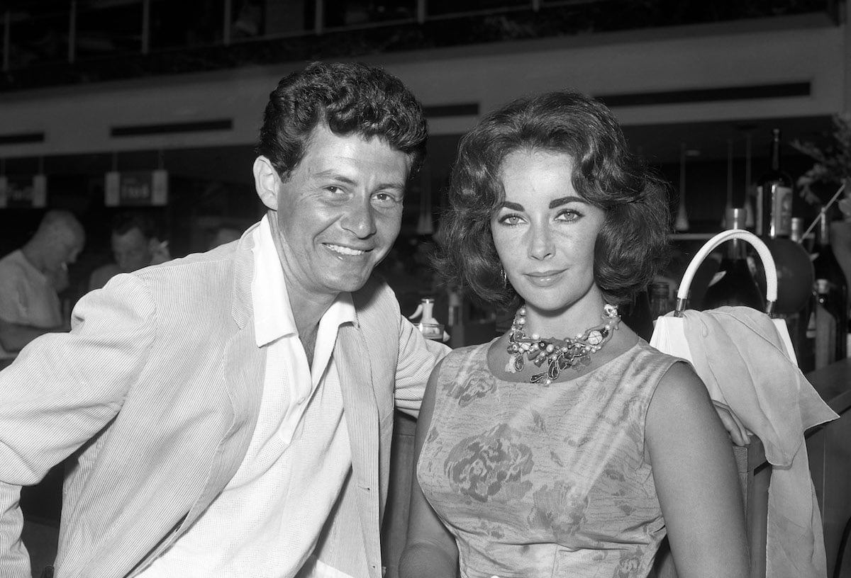Singer Eddie Fisher and his wife, film star Elizabeth Taylor, on arrival at London Airport, from a holiday in Nice | PA Images via Getty Images