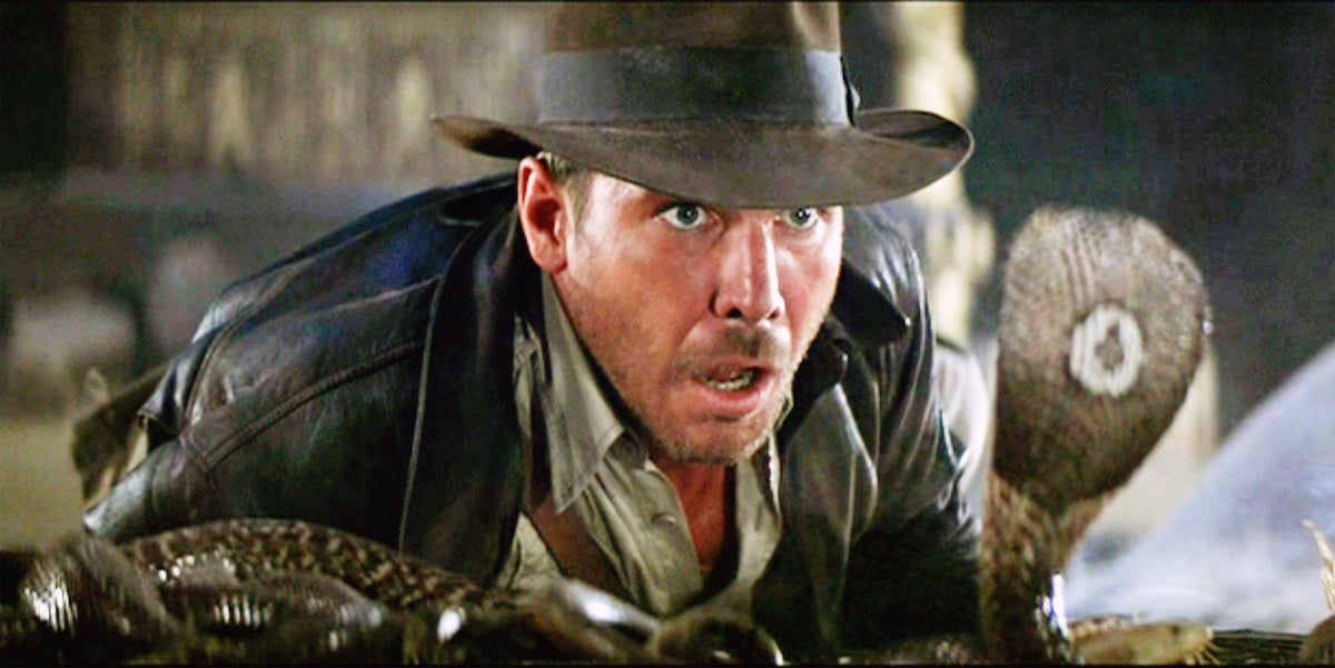 Harrison Ford as Indiana Jones facing a cobra snake in the Well of the Souls chamber. Initial theatrical release June 12, 1981.