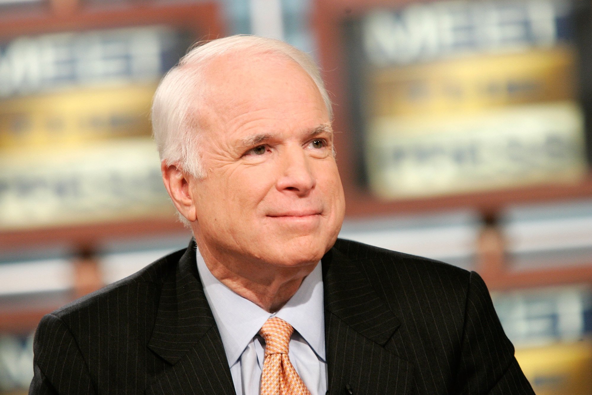 John McCain smiling, looking off camera