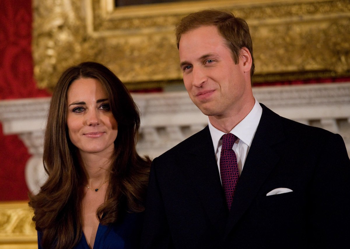 Kate Middleton and Prince William standing next to each other, smiling