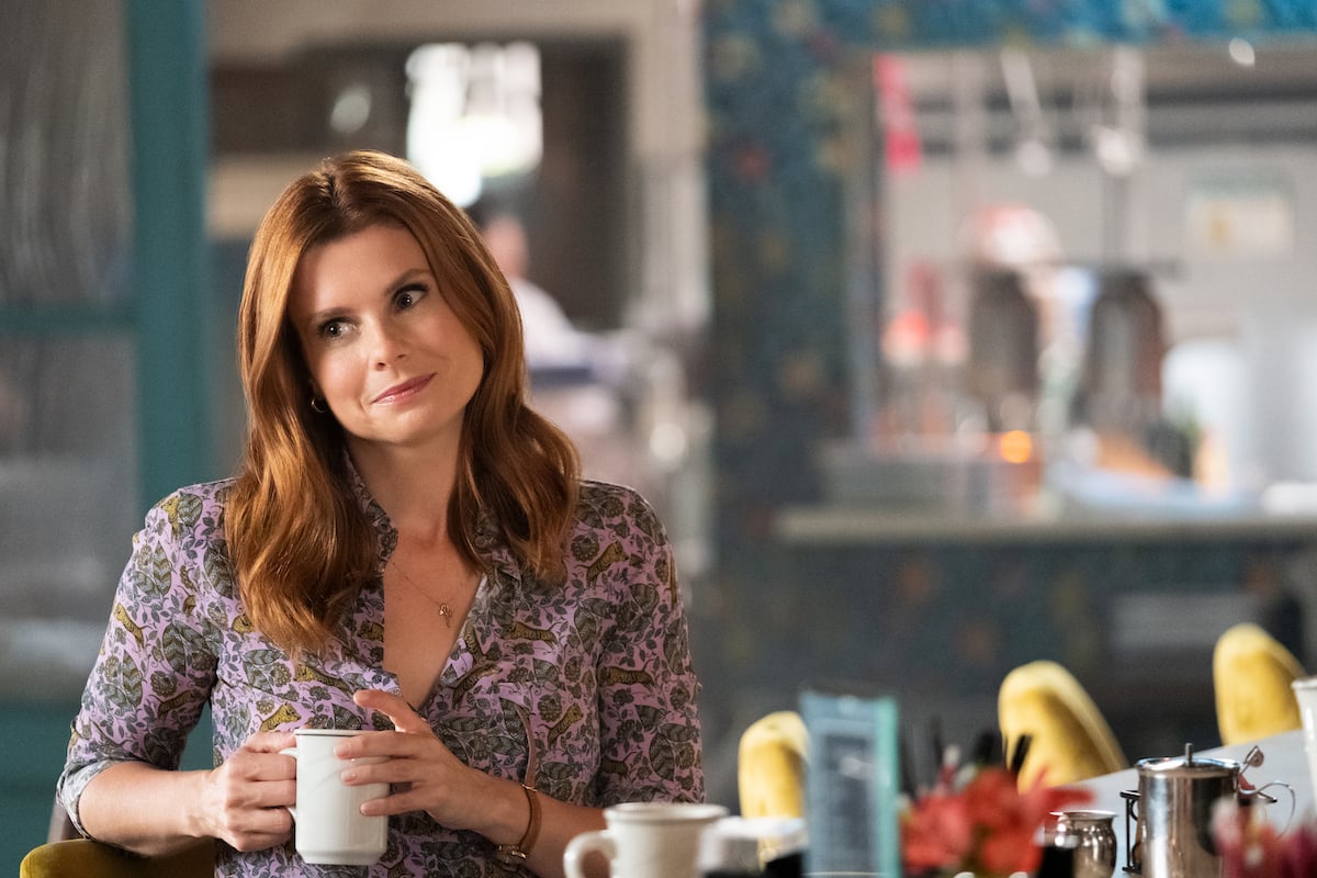 JoAnna Garcia Swisher tilting head and holding coffee cup in Sweet Magnolias 