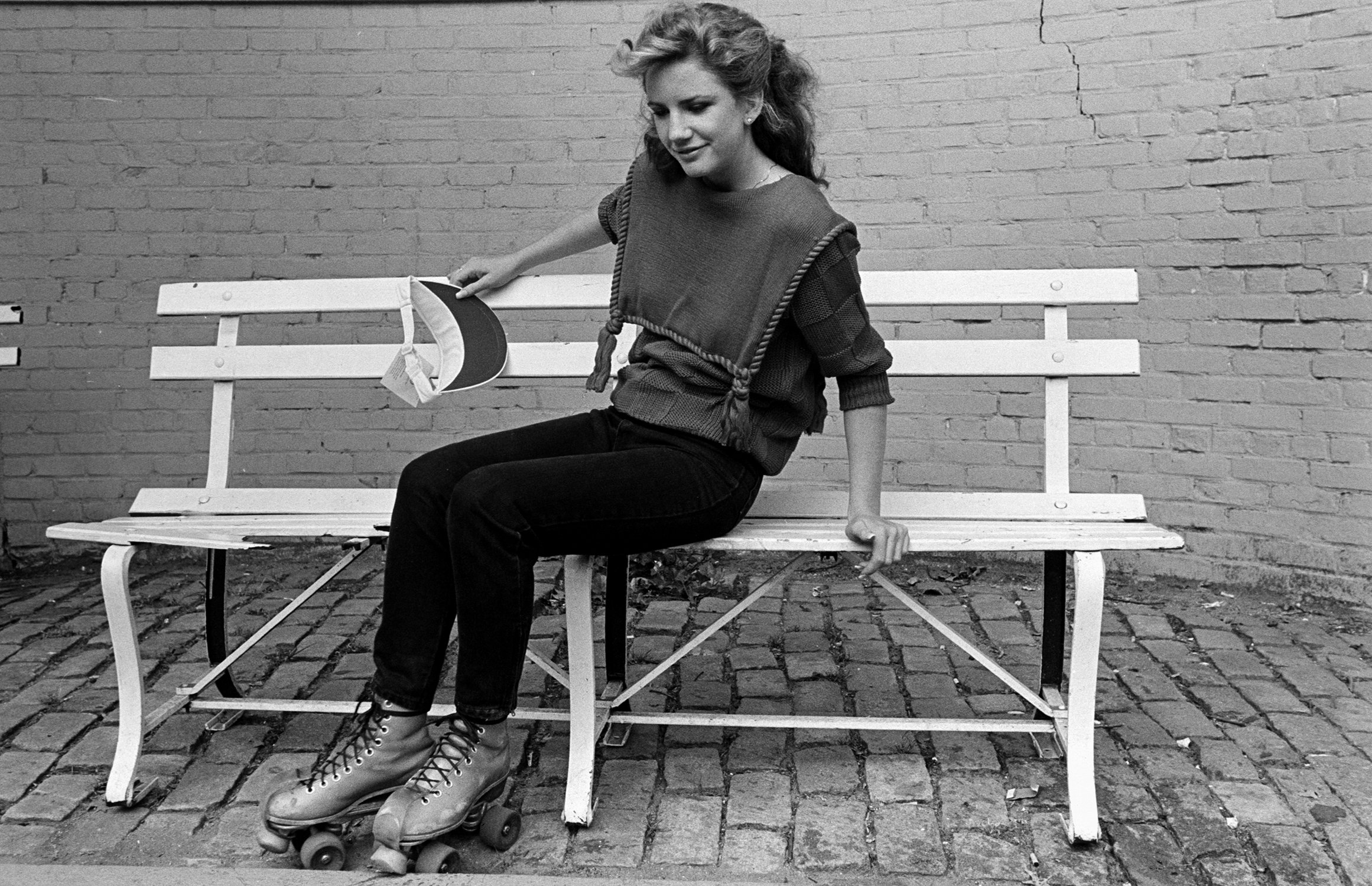 Melissa Gilbert in roller skates on a bench