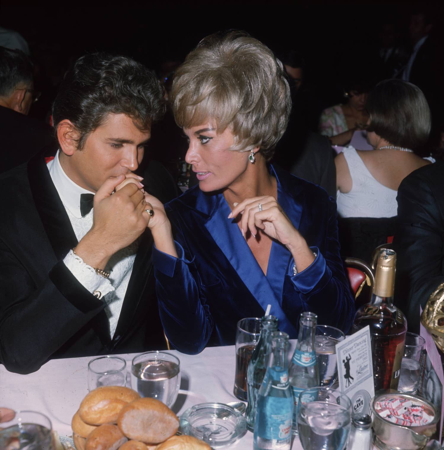 November 1966: American actor Michael Landon and his wife, Marjorie Lynn Noe, attend the opening night of singer Susan Barrett's performances at the Cocoanut Grove, Hollywood, California. Landon is kissing his wife's hand. 