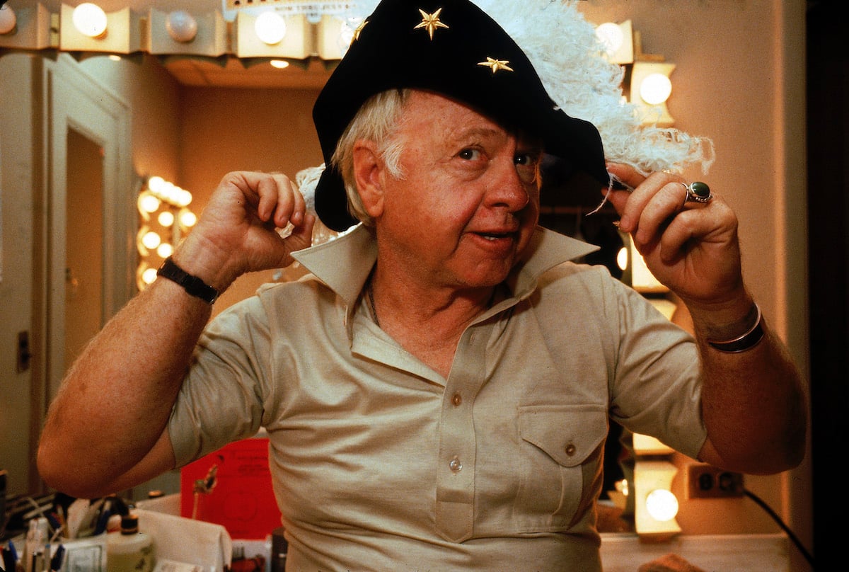 Mickey Rooney tries on a feathered hat in his dressing room in the Mark Hellinger Theatre