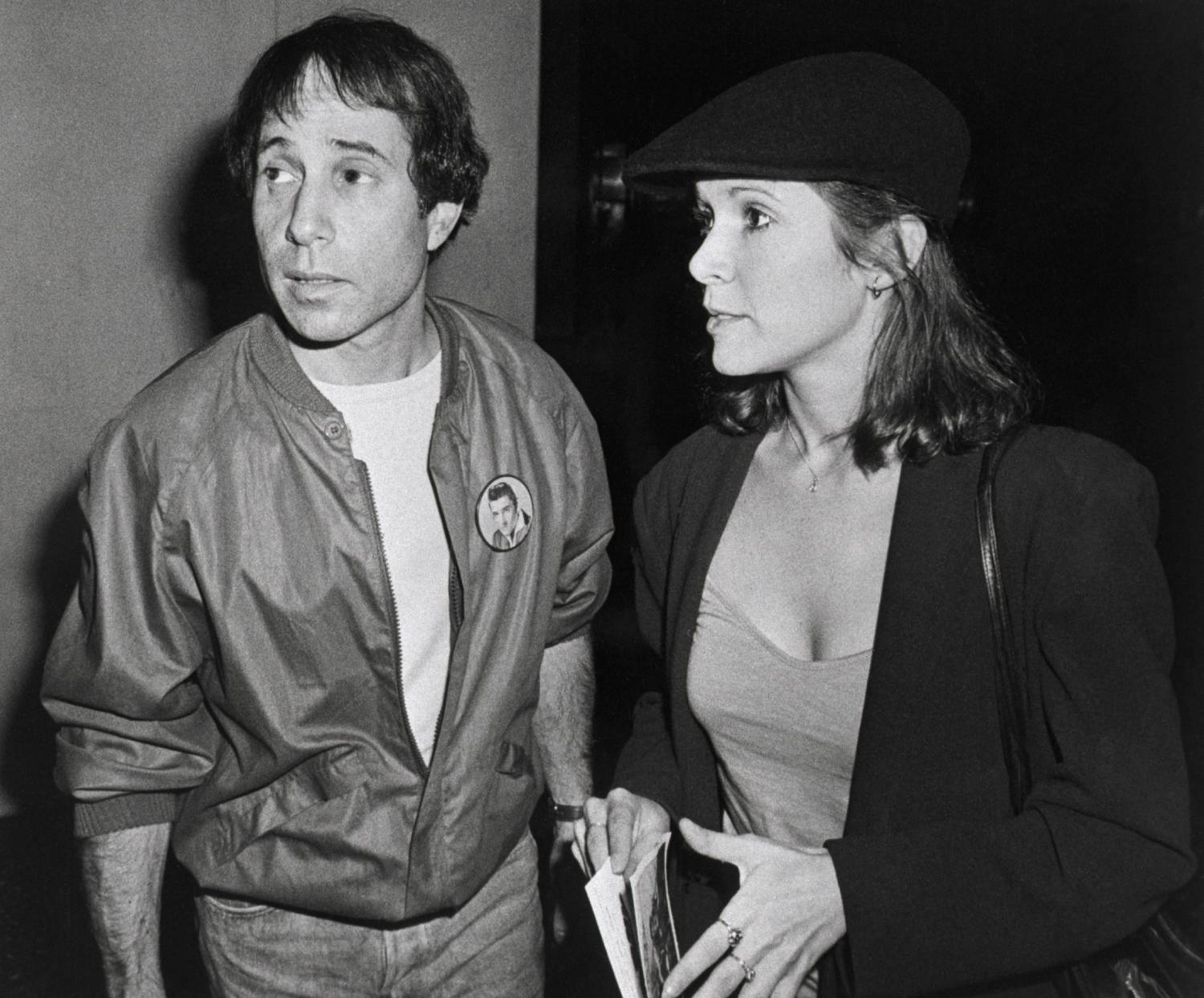 (Original Caption) 6/3/1980-New York: Singer-composer Paul Simon and actress Carrie Fisher at a reception following a private screening of the movie "Carney," which stars Gary Busey