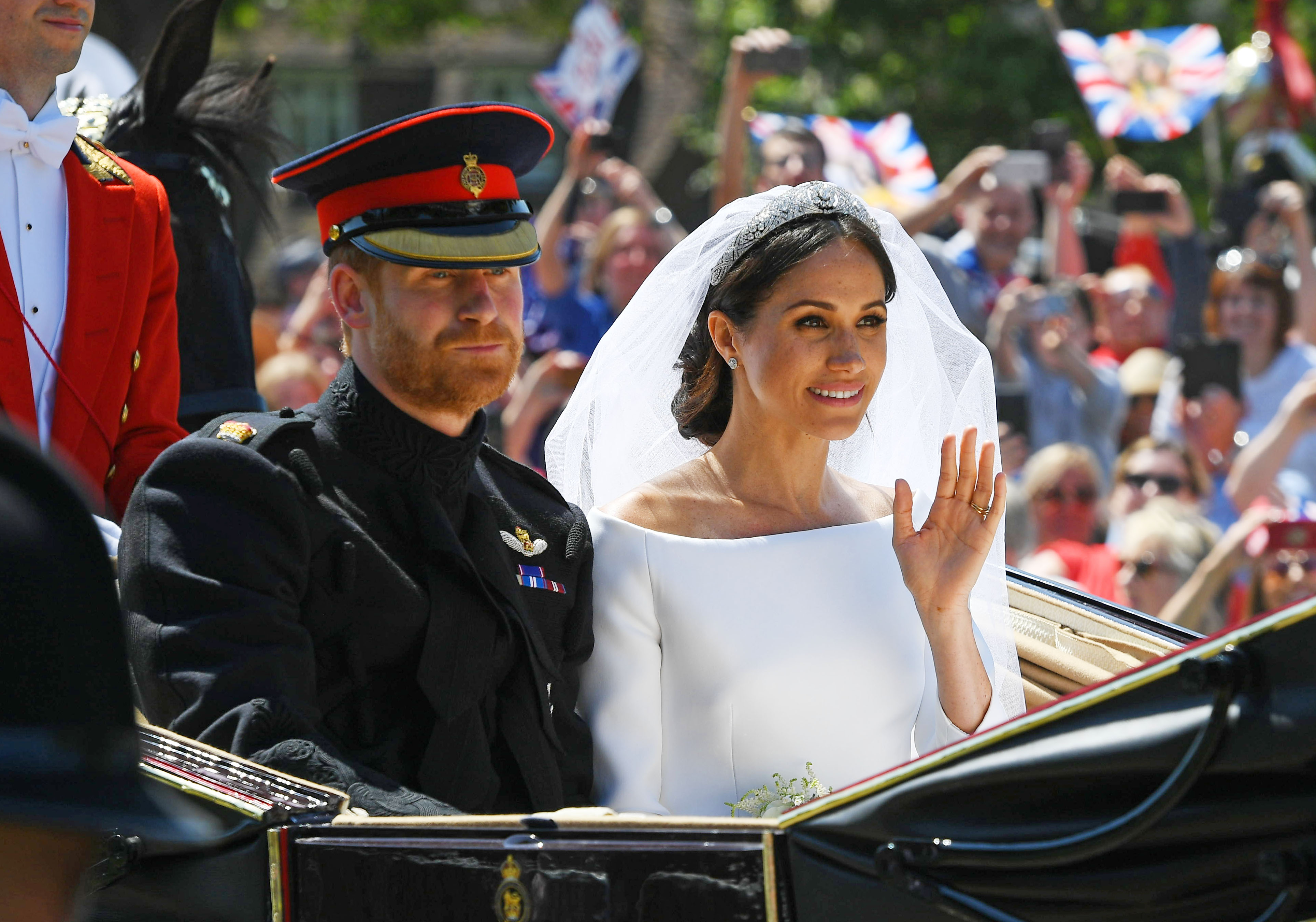 Prince Harry and Meghan Markle ride in a carriage at the royal wedding