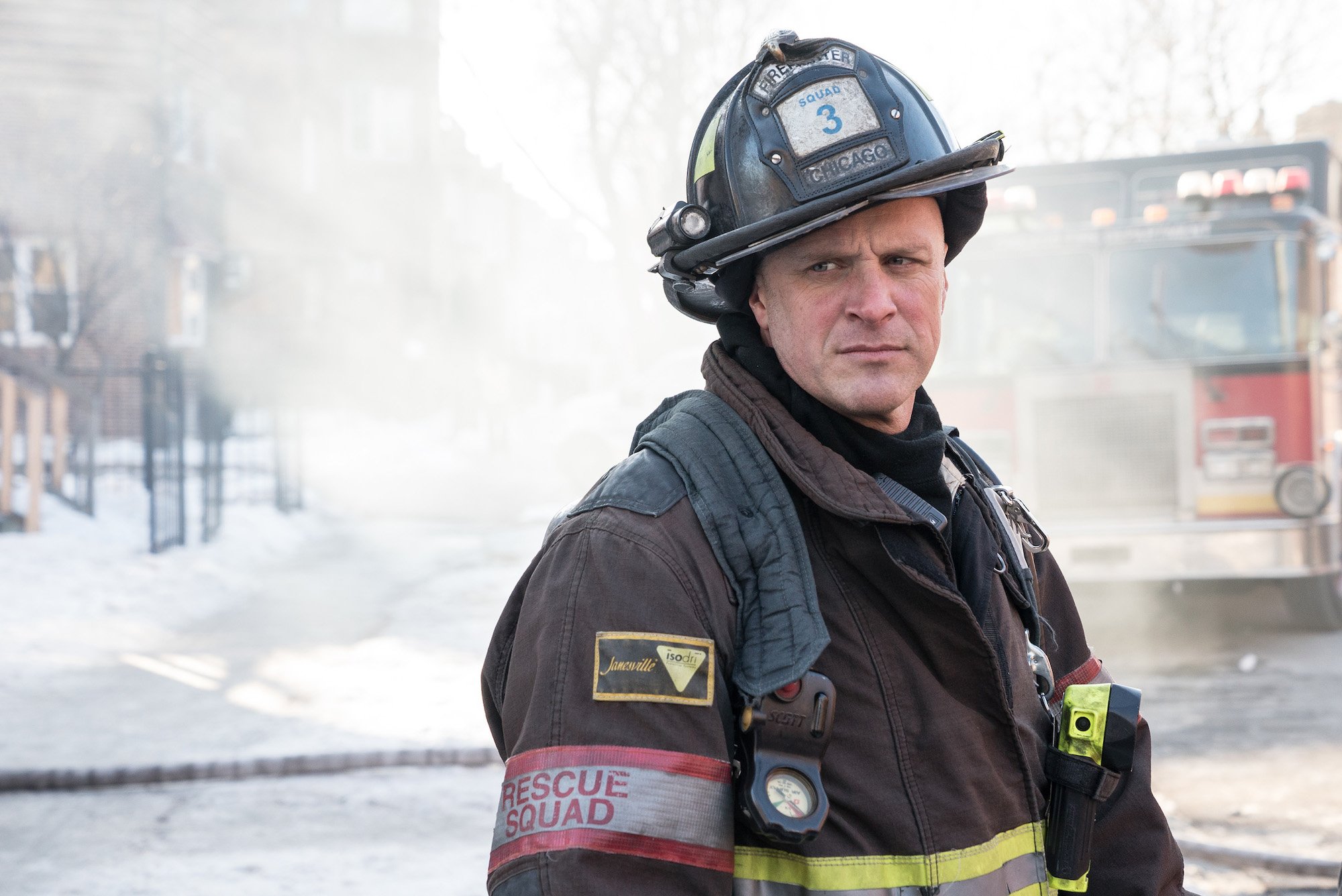 Randy Flagler as Capp, turned to the side in front of a smoky background, on 'Chicago Fire'