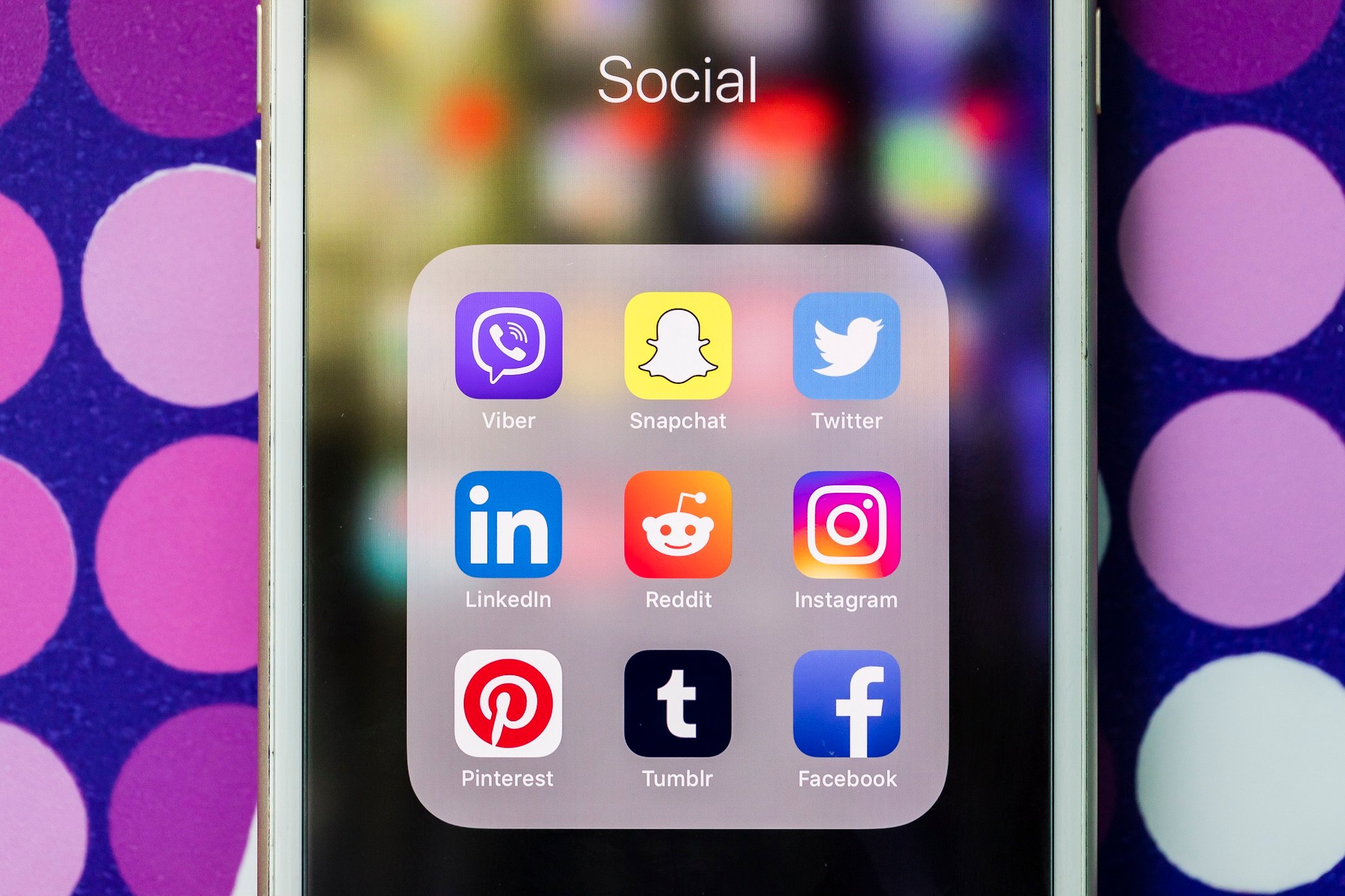 A smart phone with the icons for the social networking apps Viber, Snapchat, Twitter, Linkedin, Reddit, Instagram, Pinterest, Tumblr, and Facebook