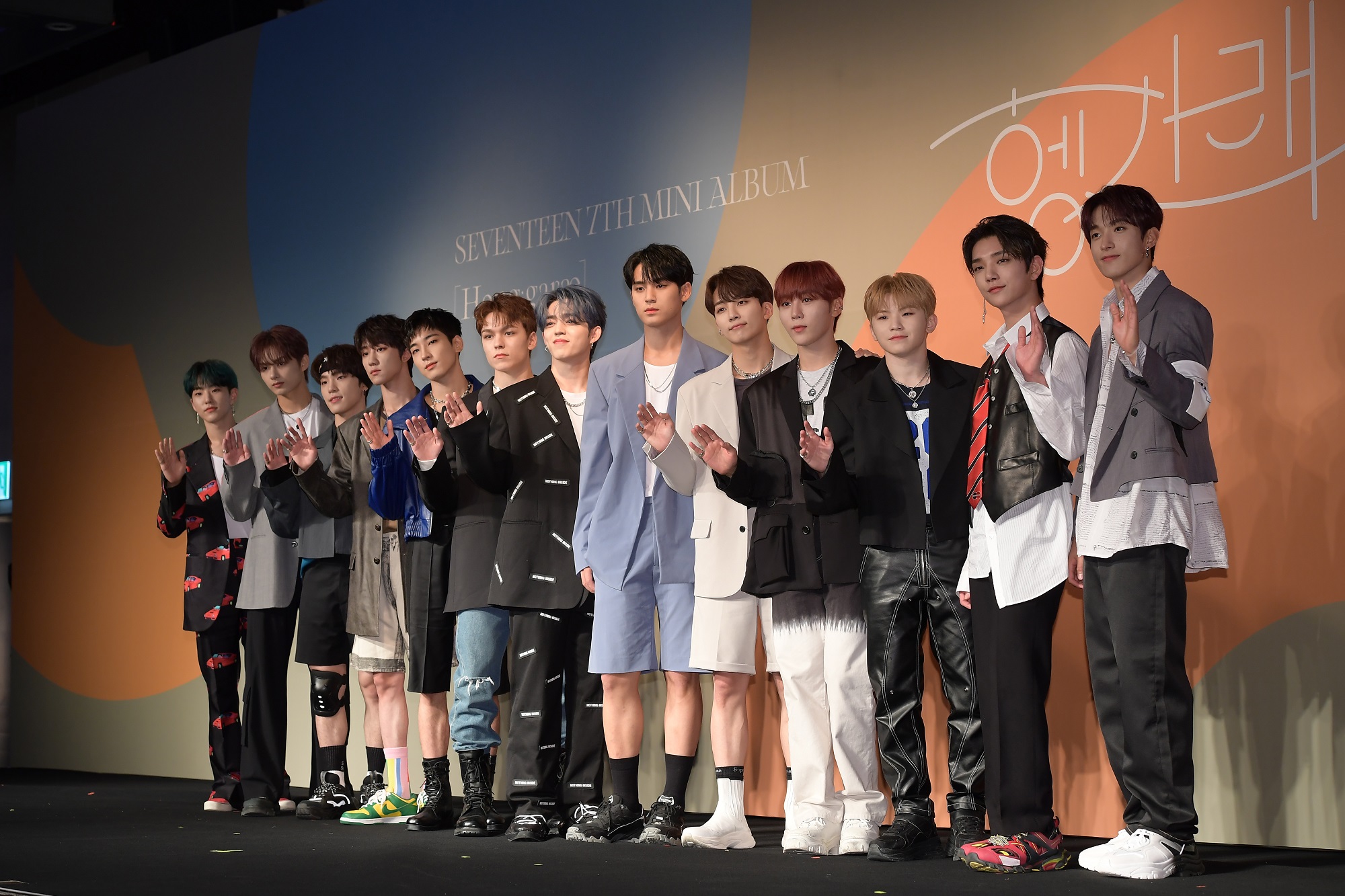 The members of SEVENTEEN stand on stage at a media showcase for their mini album 'HENGGARAE'