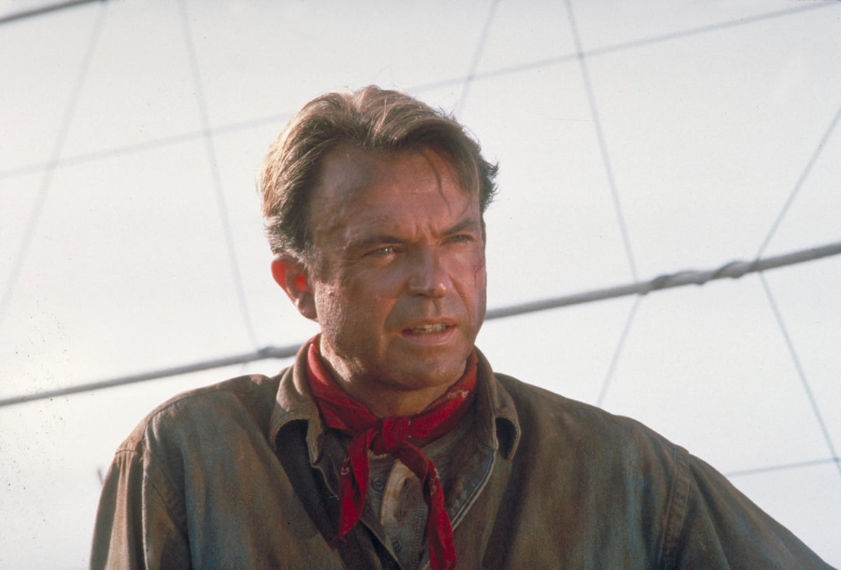 Sam Neill as Dr. Alan Grant, next to an electric fence in a scene from the film 'Jurassic Park', 1993.