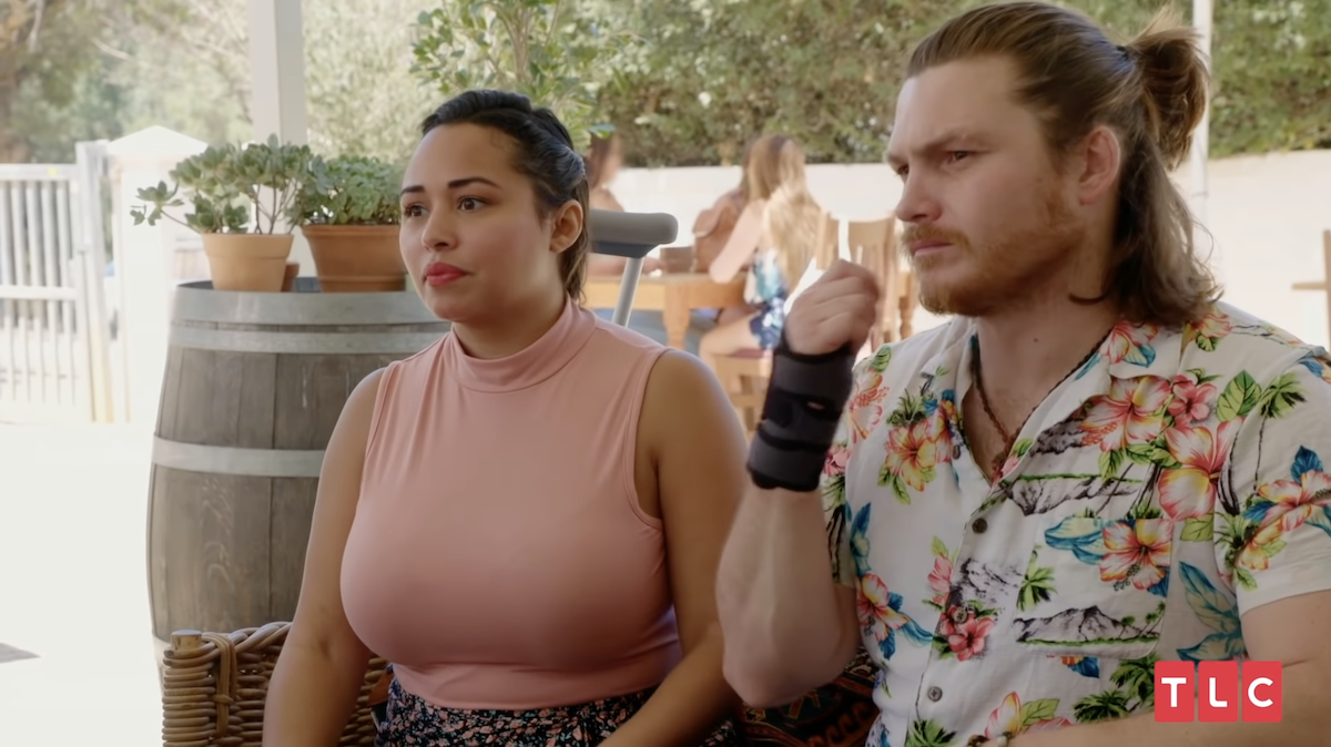 Tania Maduro and Syngin Colchester on ’90 Day Fiancé’ -- the two sit together looking troubled, Syngin wears a wrist brace. Are Tania and Syngin still together?