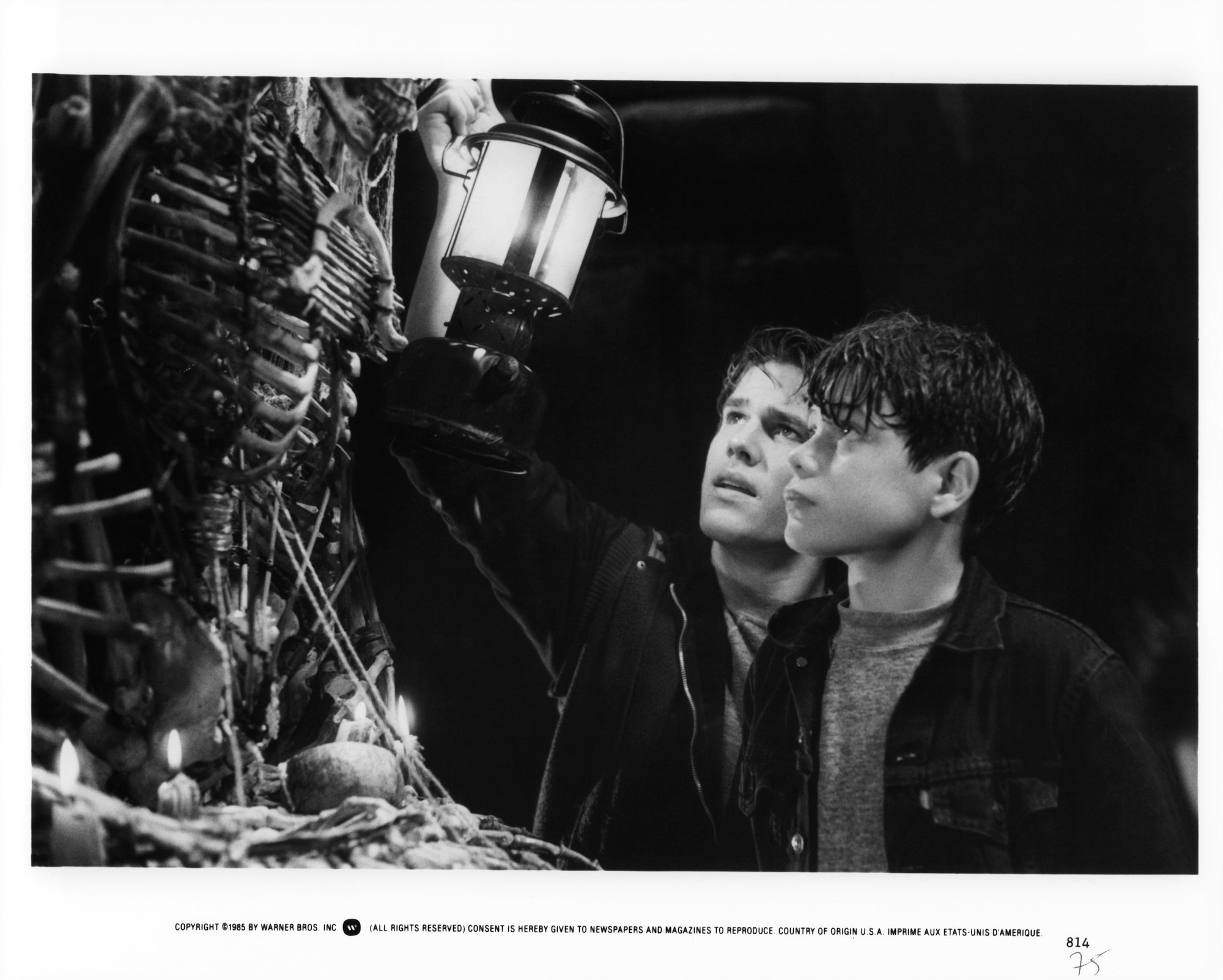 Josh Brolin and Sean Astin hold up a light to bones in a scene from the 1985 film 'The Goonies.'