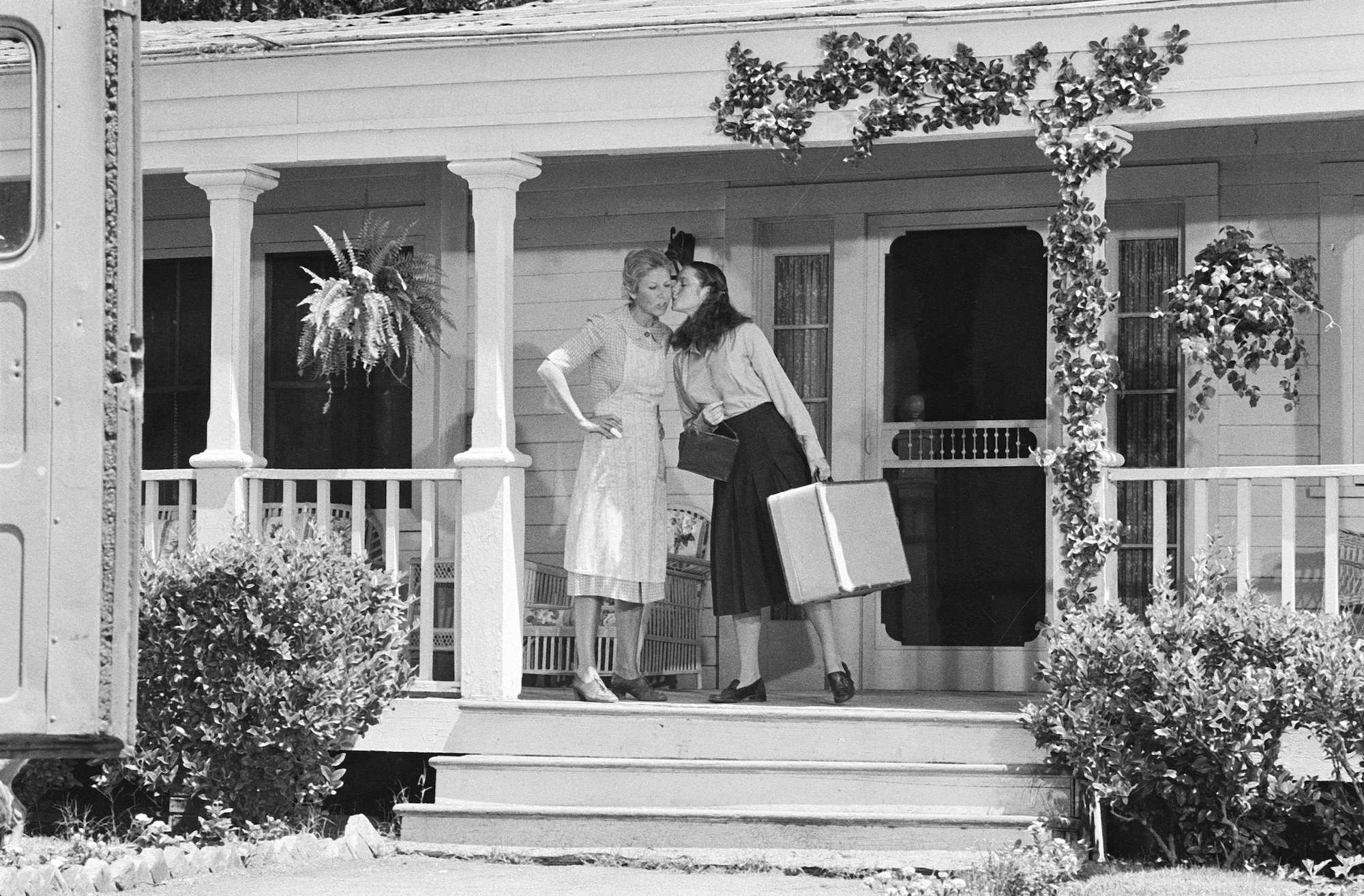 (L-R) Michael Learned as Olivia Walton and Mary McDonough as Erin Walton on a porch on 'The Waltons'