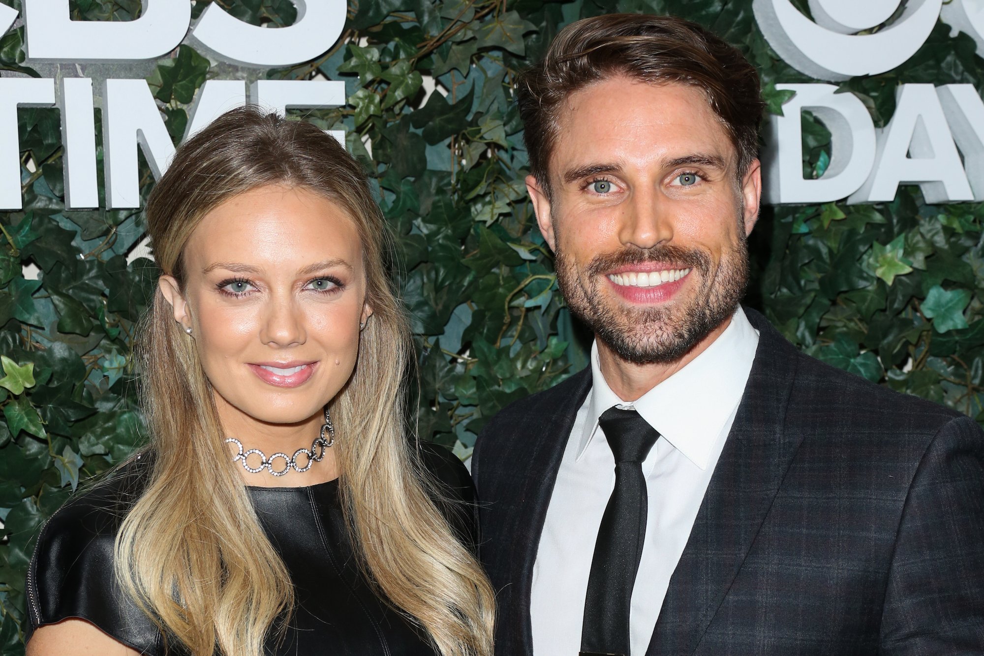 (L-R) Melissa Ordway and Justin Gaston smiling in front of a green background