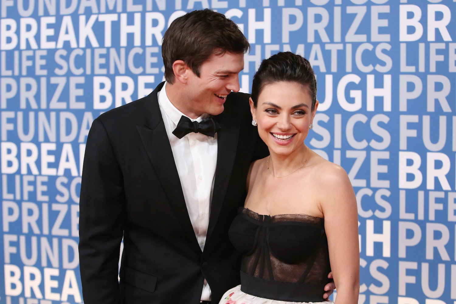 Ashton Kutcher and Mila Kunis pose for photographers at the 2018 Breakthrough Prize