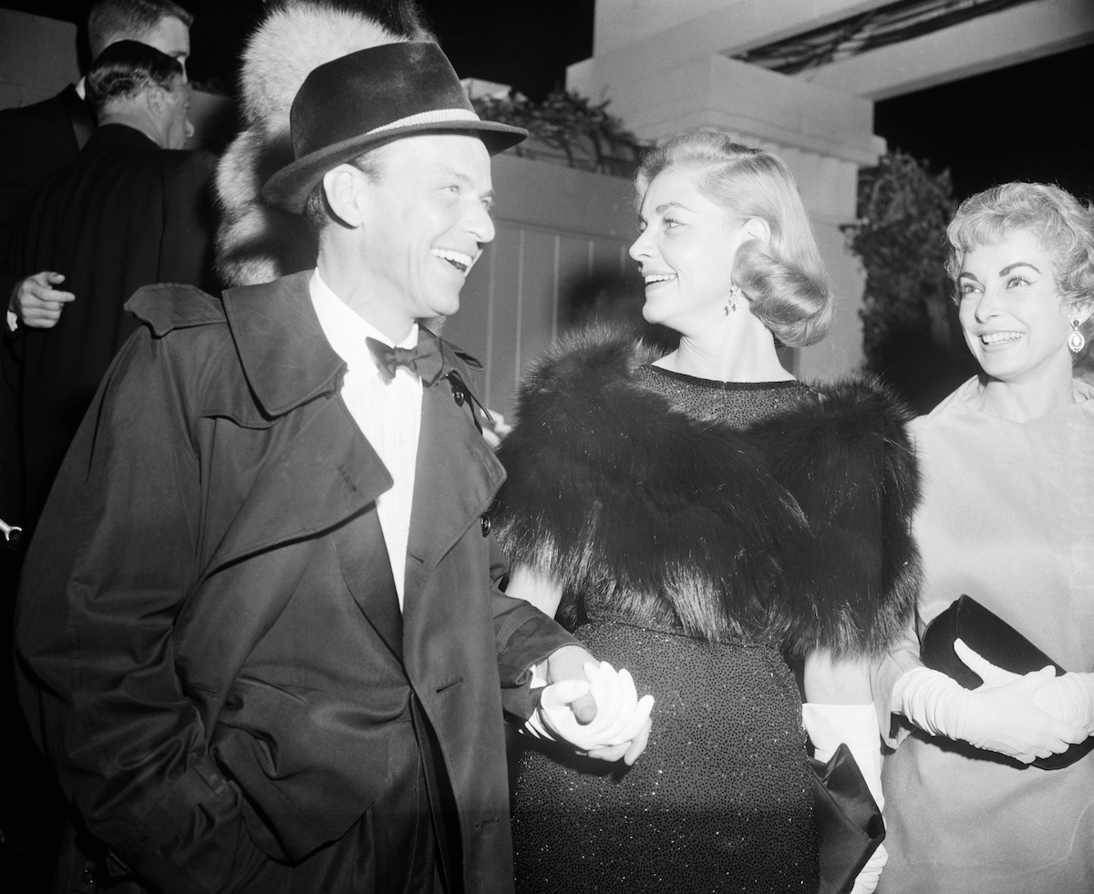 Frank Sinatra and Lauren Bacall holding hands