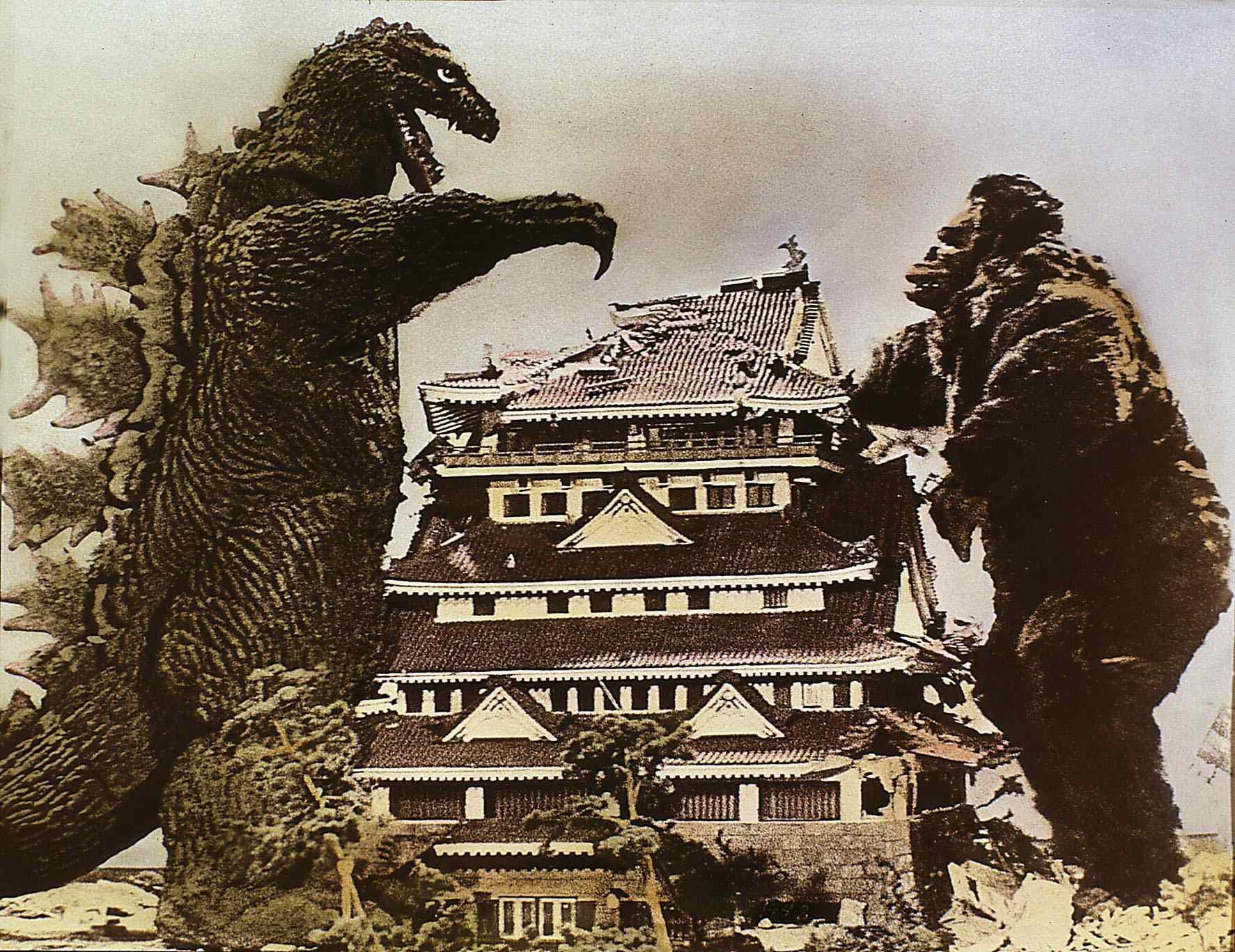 Godzilla and King Kong near a building