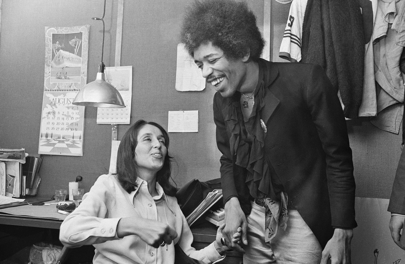 Joan Baez and Jimi Hendrix laughing