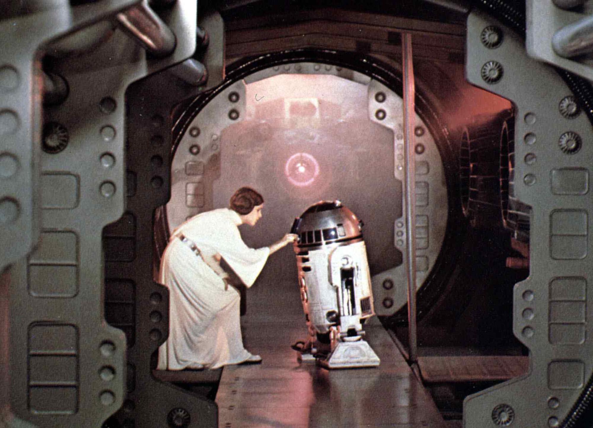 Carrie Fisher as Princess Leia and R2-D2 (Kenny Baker) in 'Star Wars: Episode IV — A New Hope'
