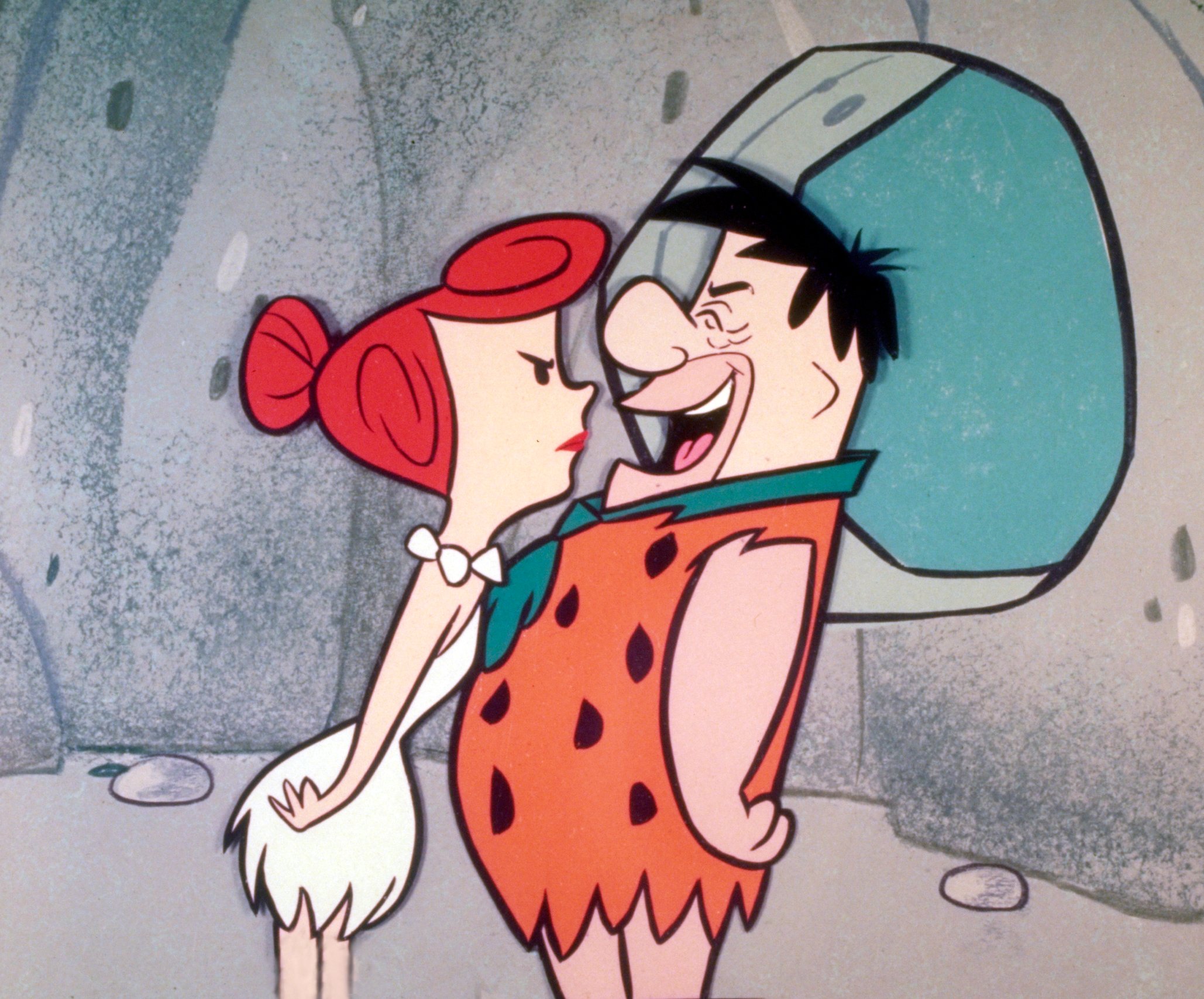 Wilma and Fred from The Flintstones in their house