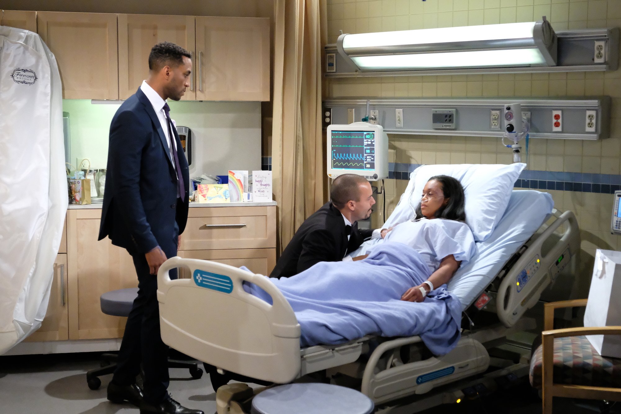 Nate (Brooks Darnell) looks on as Devon (Bryton James) comforts Hilary (Mishael Morgan)