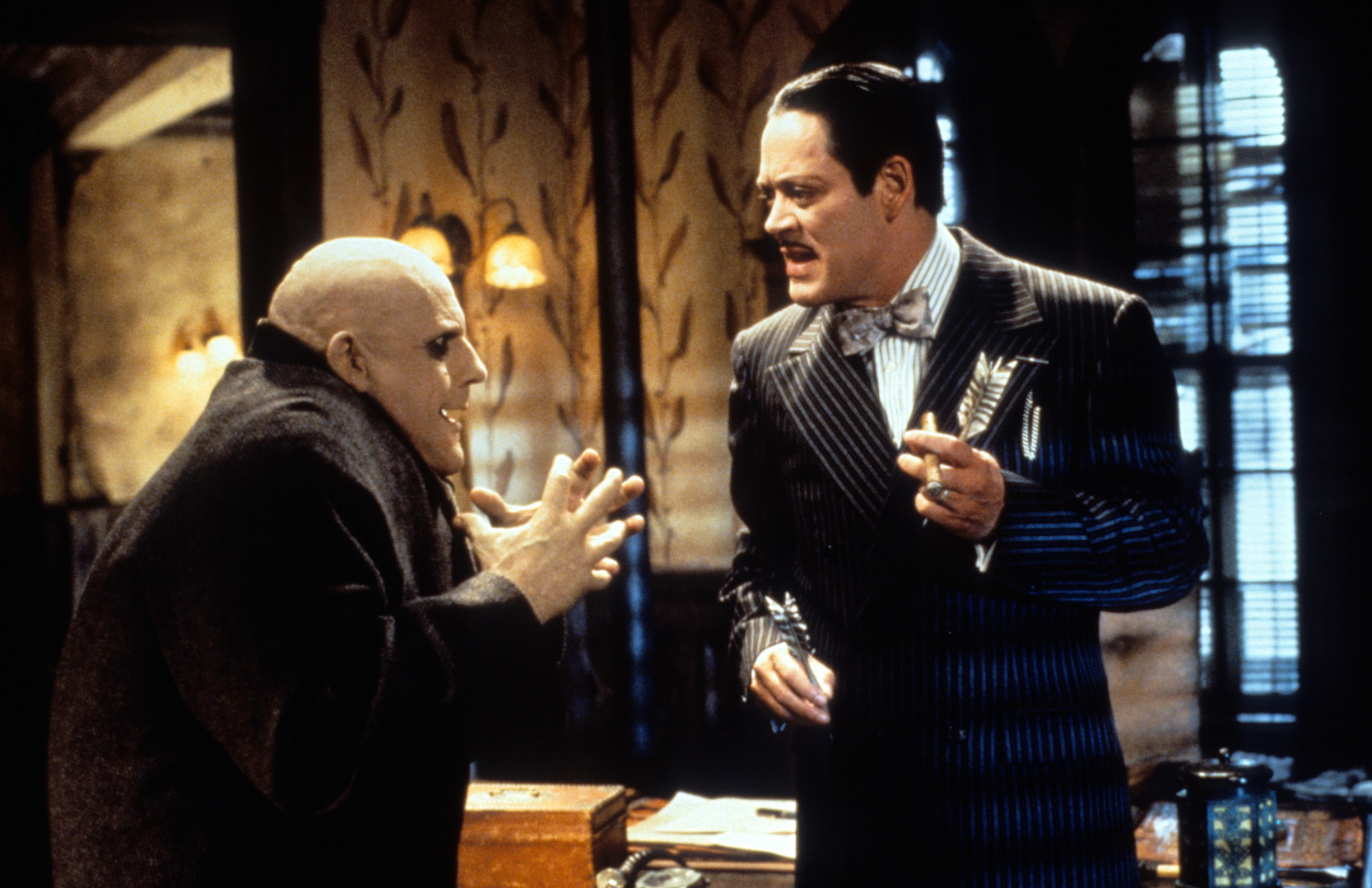 Christopher Lloyd and Raul Julia talking in a scene from the movie 'Addams Family Values'