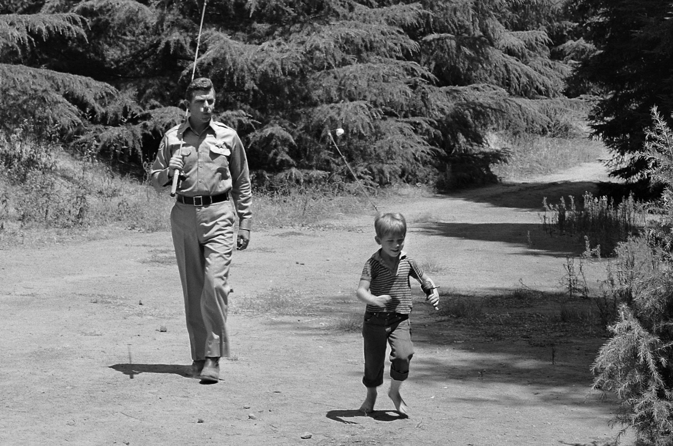 Andy Griffith as Sheriff Andy Taylor and Ron Howard as his son Opie walking to the fishing hole on 'The Andy Griffith Show'