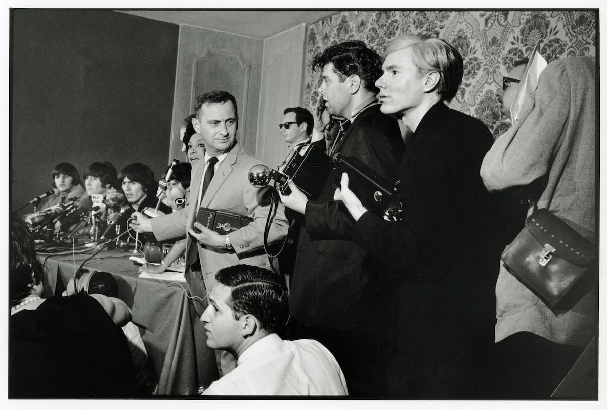 The Beatles being interviewed by the media with Andy Warhol