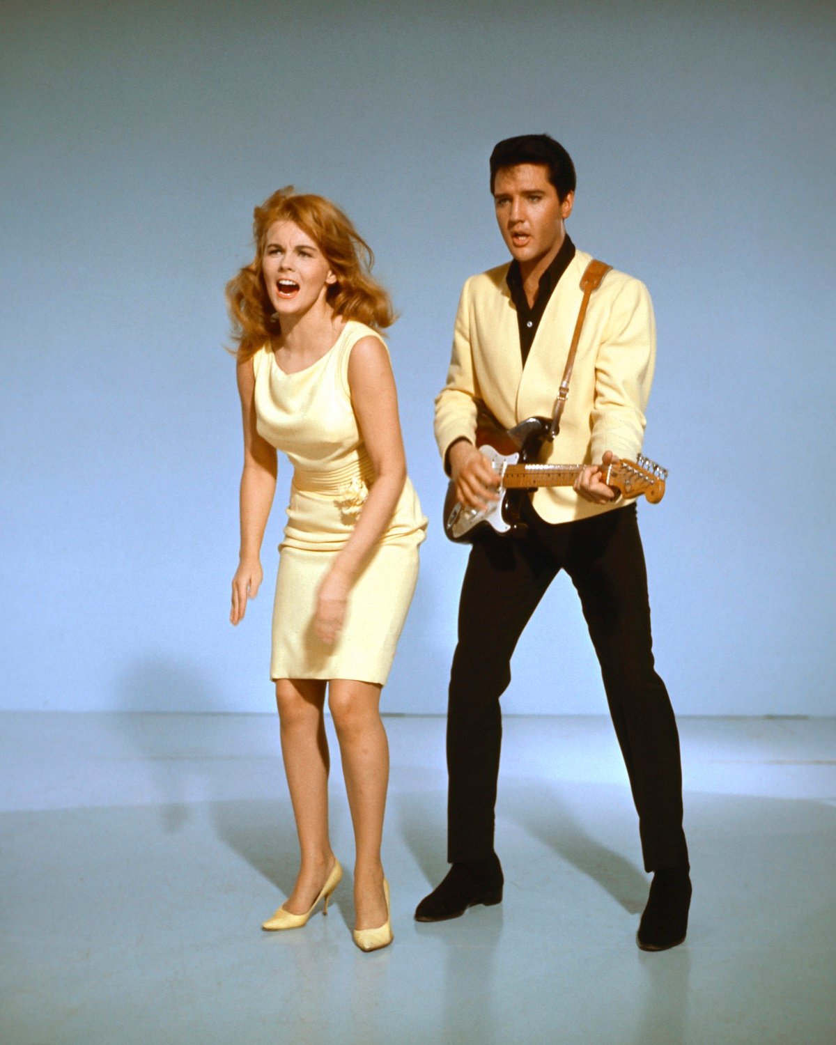 Elvis Presley with a guitar and Ann-Margret singing in a publicity shot for 'Viva Las Vegas' 