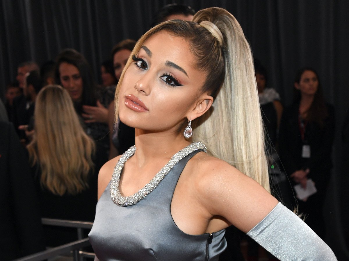 Ariana Grande in a grey gown and her hair in a ponytail on the red carpet of the 2020 GRAMMY Awards on Jan. 26, 2020 | Kevin Mazur/Getty Images for The Recording Academy
