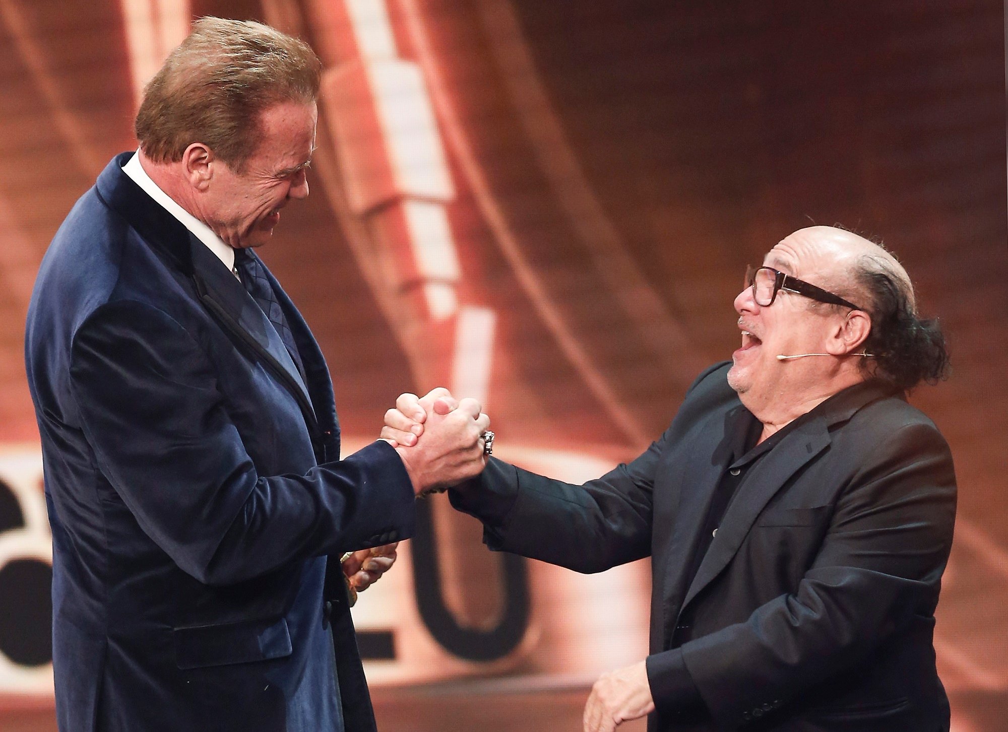 Arnold Schwarzenegger and Danny DeVito on stage