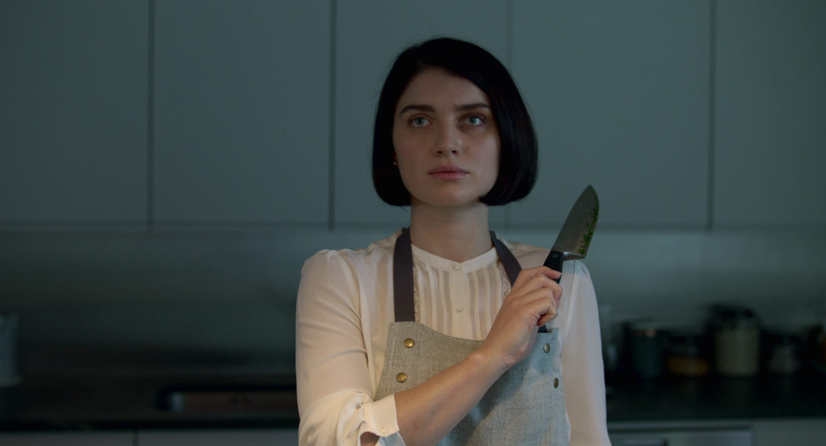 Eve Hewson as Adele holds up a knife in 'Behind Her Eyes; season 1