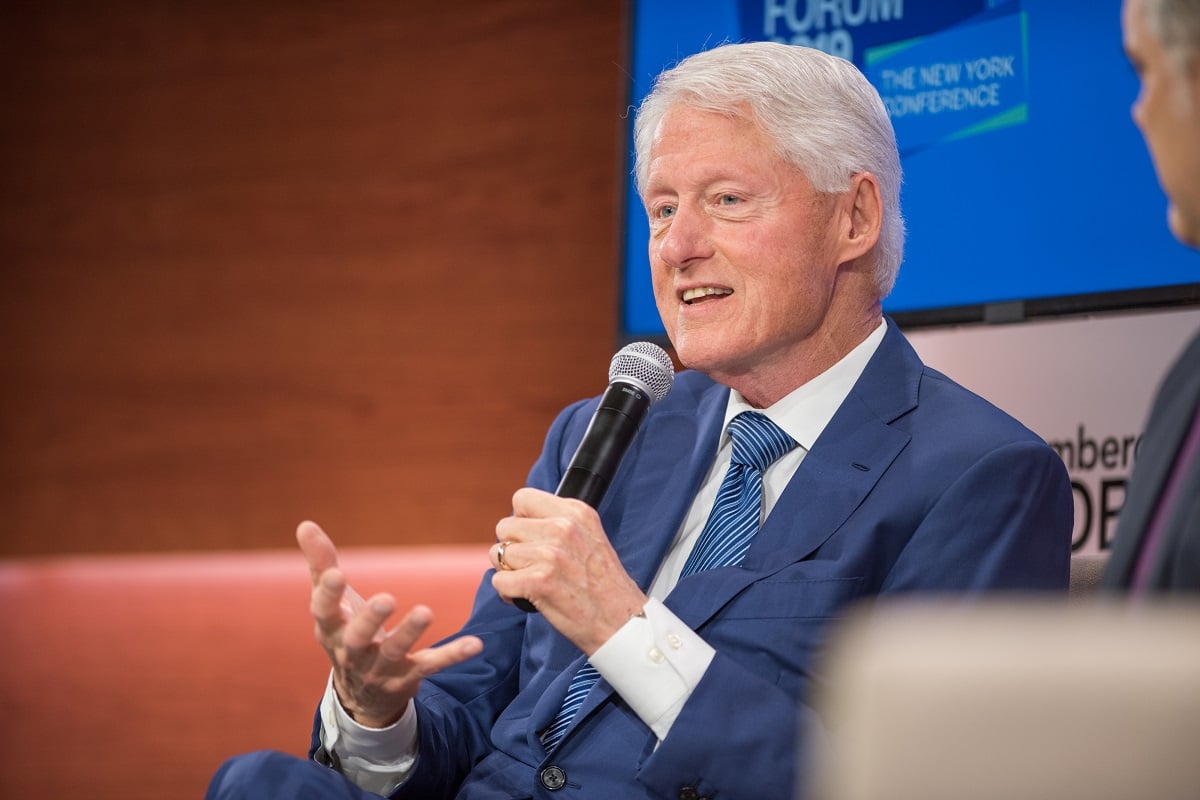 Bill Clinton speaking into a microphone during the Bloomberg Business Week Forum in 2019