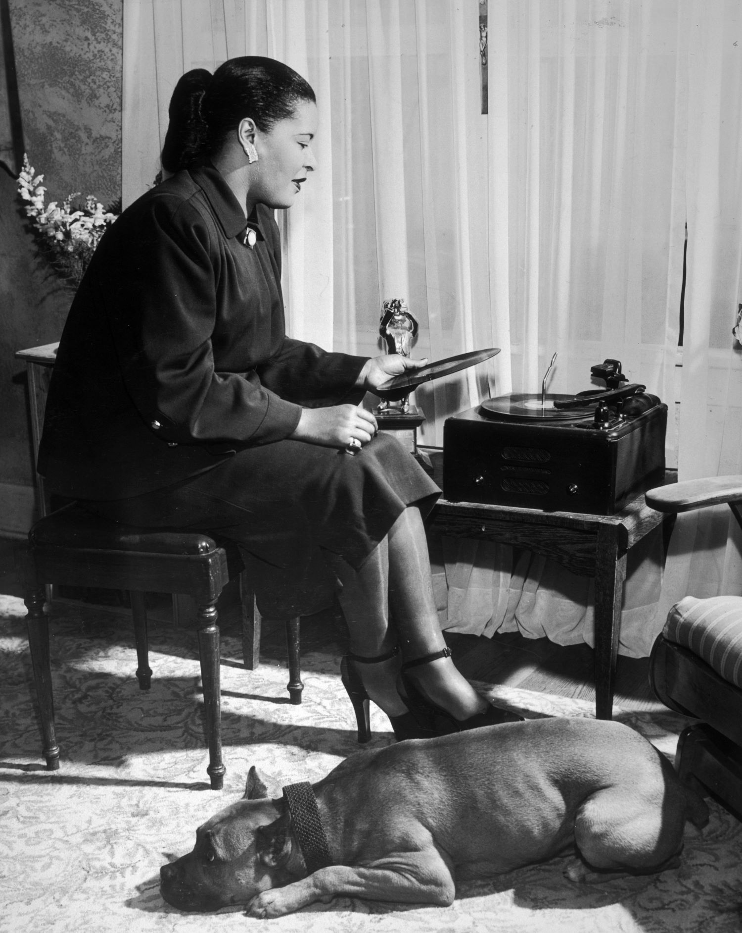 Billie Holiday and dog laying by her feet
