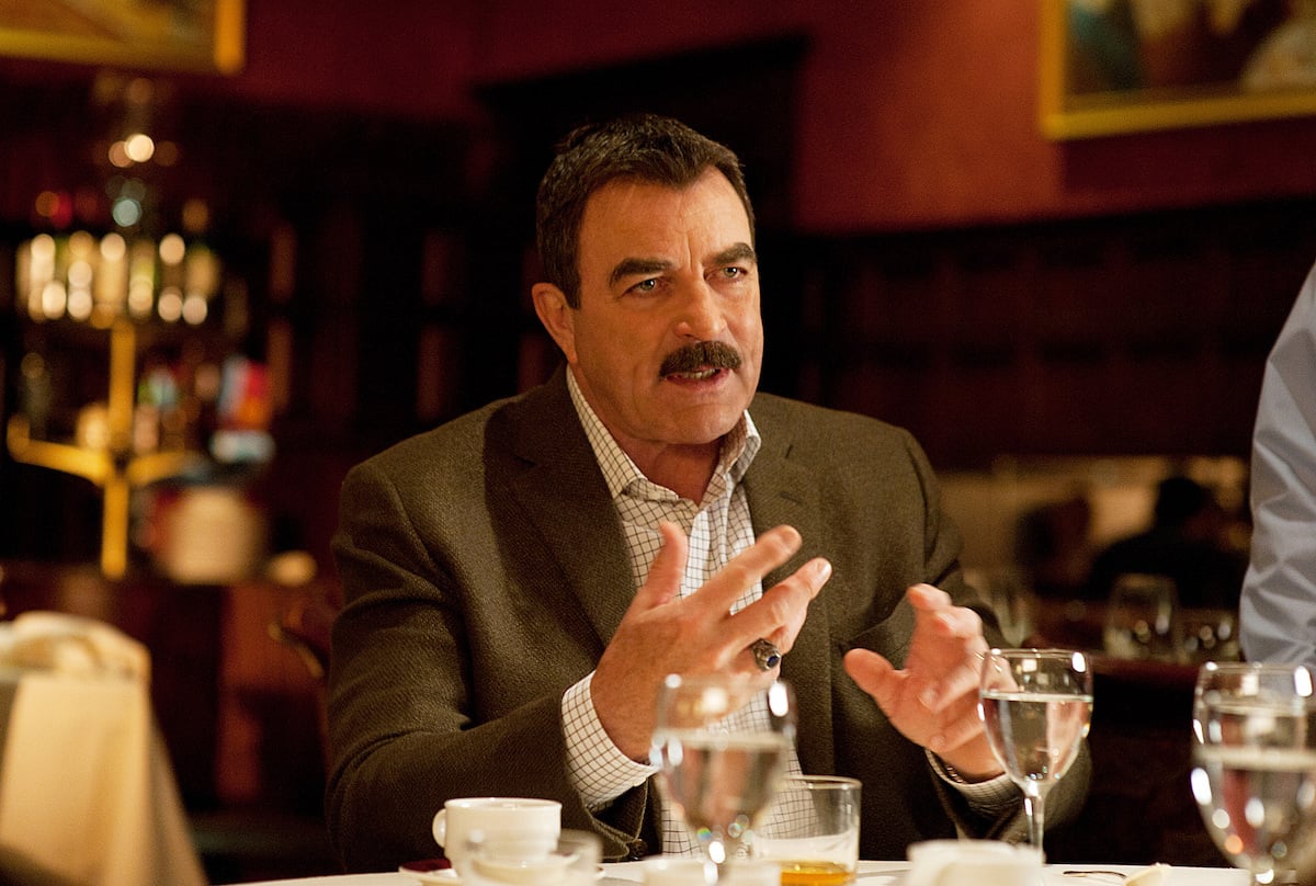 Tom Selleck as Frank Reagan talks while sitting in a restaurant on 'Blue Bloods'