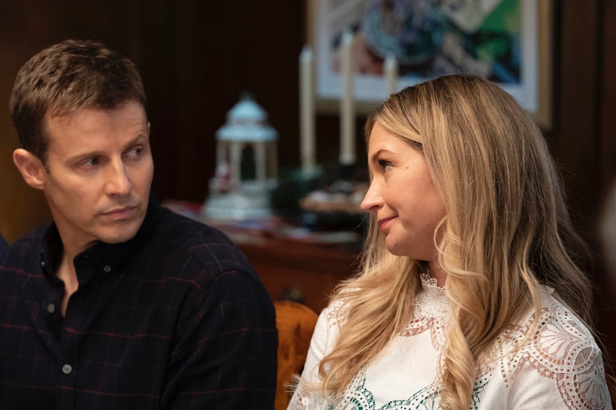 Jamie side eyes Eddie as they sit next to each other on 'Blue Bloods'