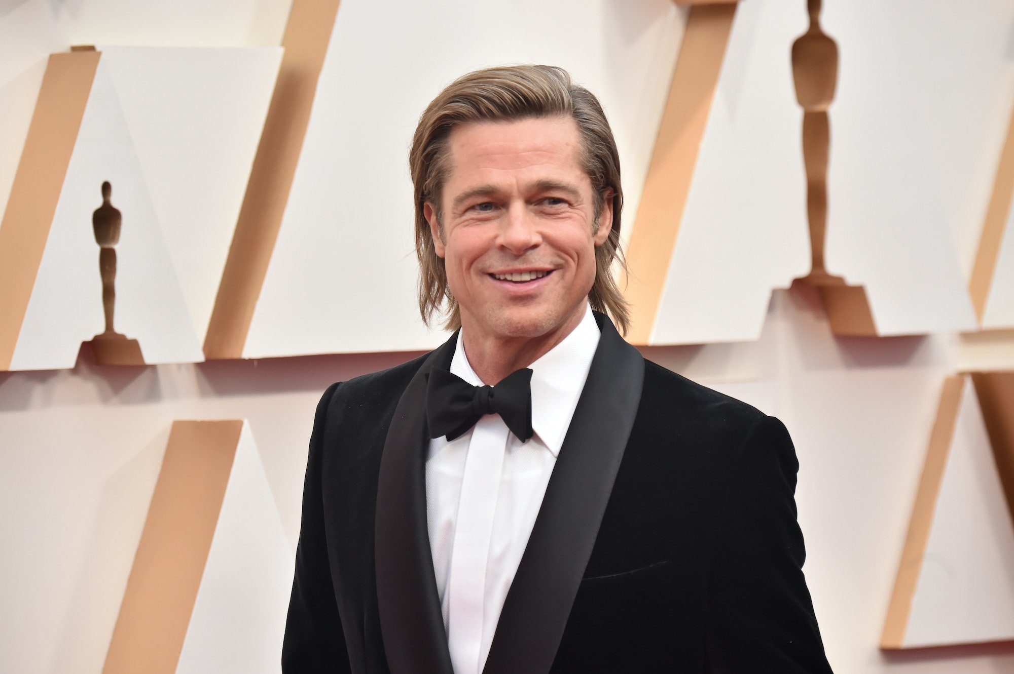 Brad Pitt smiling, turned slightly to the side