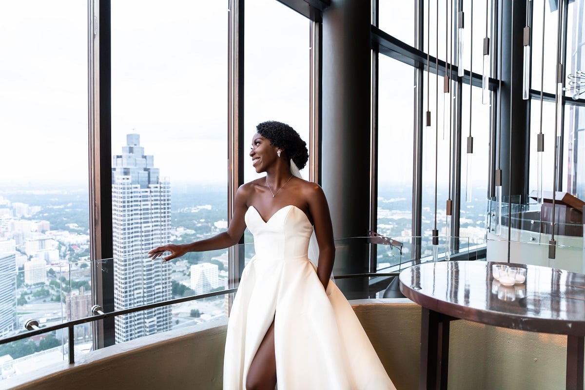 Briana Morris in her wedding gown looking out the hotel window on 'Married at First Sight'