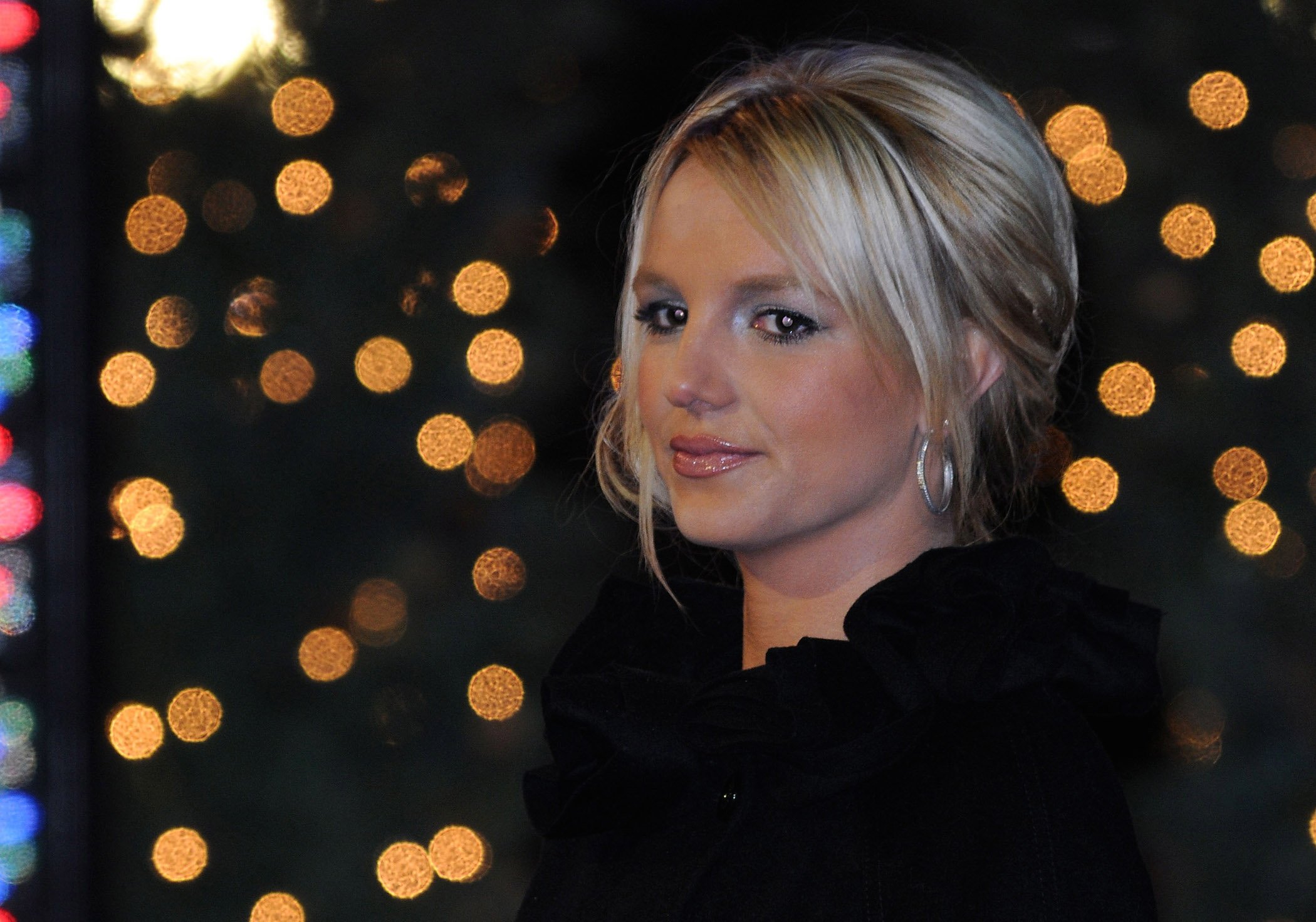 A head shot of Britney Spears in 2008 wearing a black coat